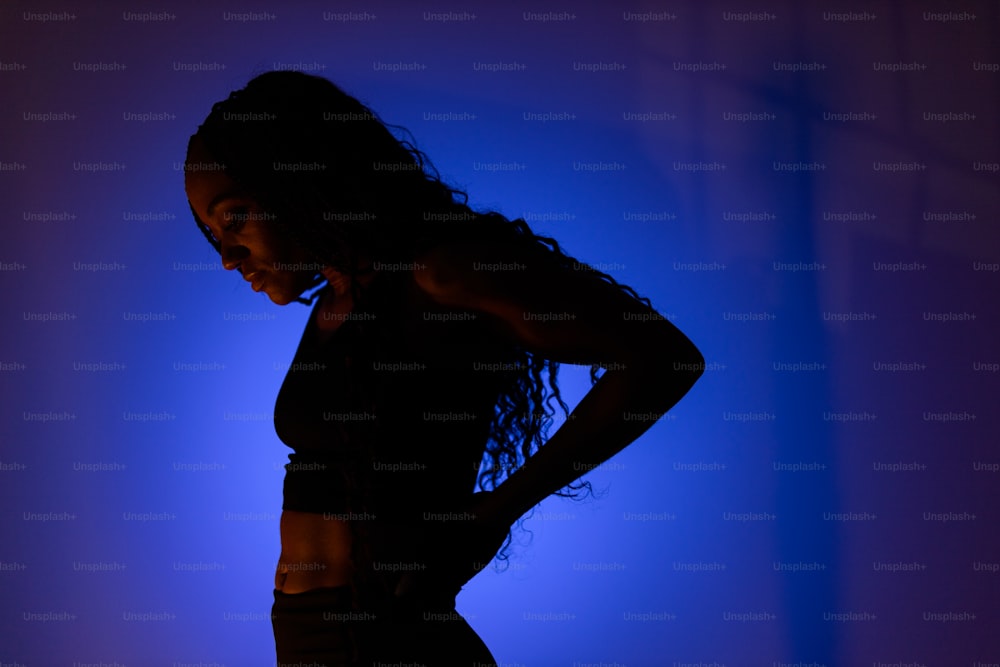 a woman standing in front of a blue background