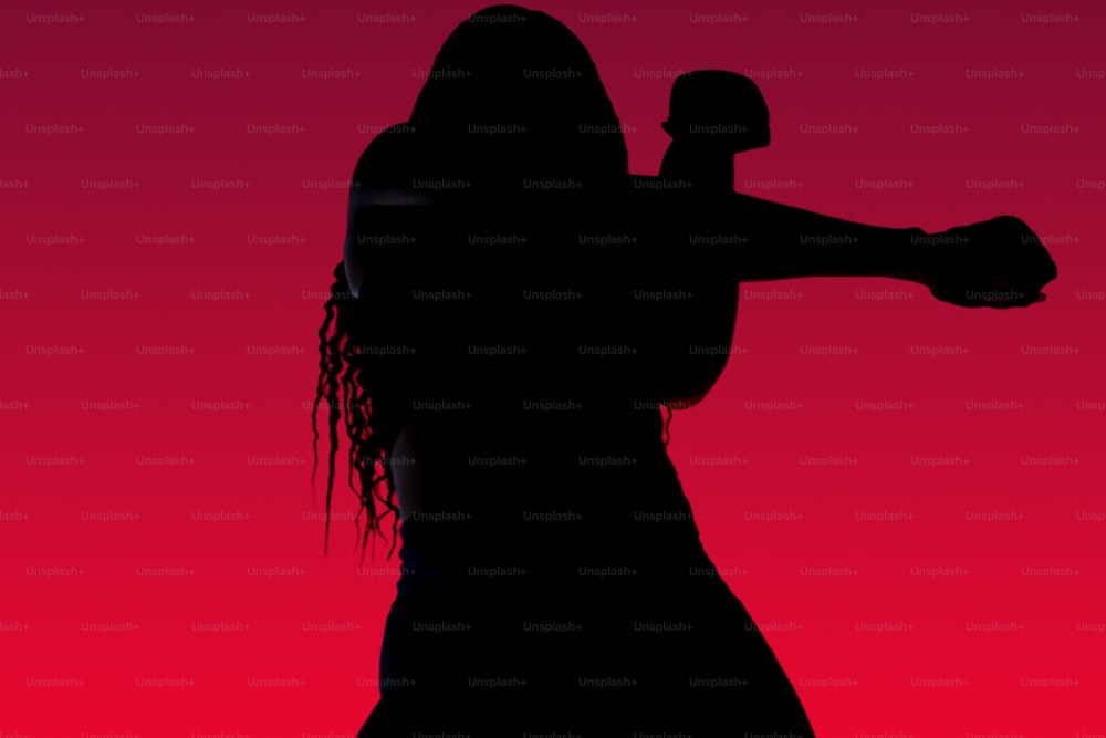 a silhouette of a woman holding a baseball bat