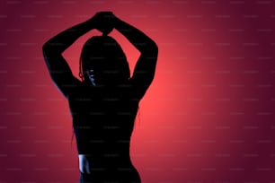 a silhouette of a woman with her hands on her head