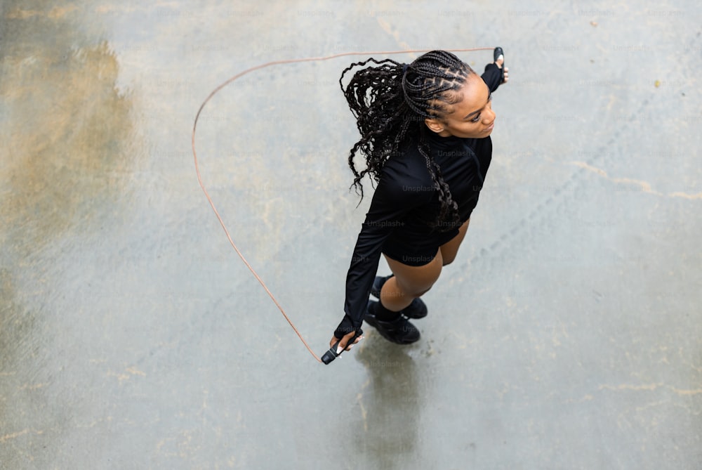 a woman holding a tennis racquet on top of a tennis court