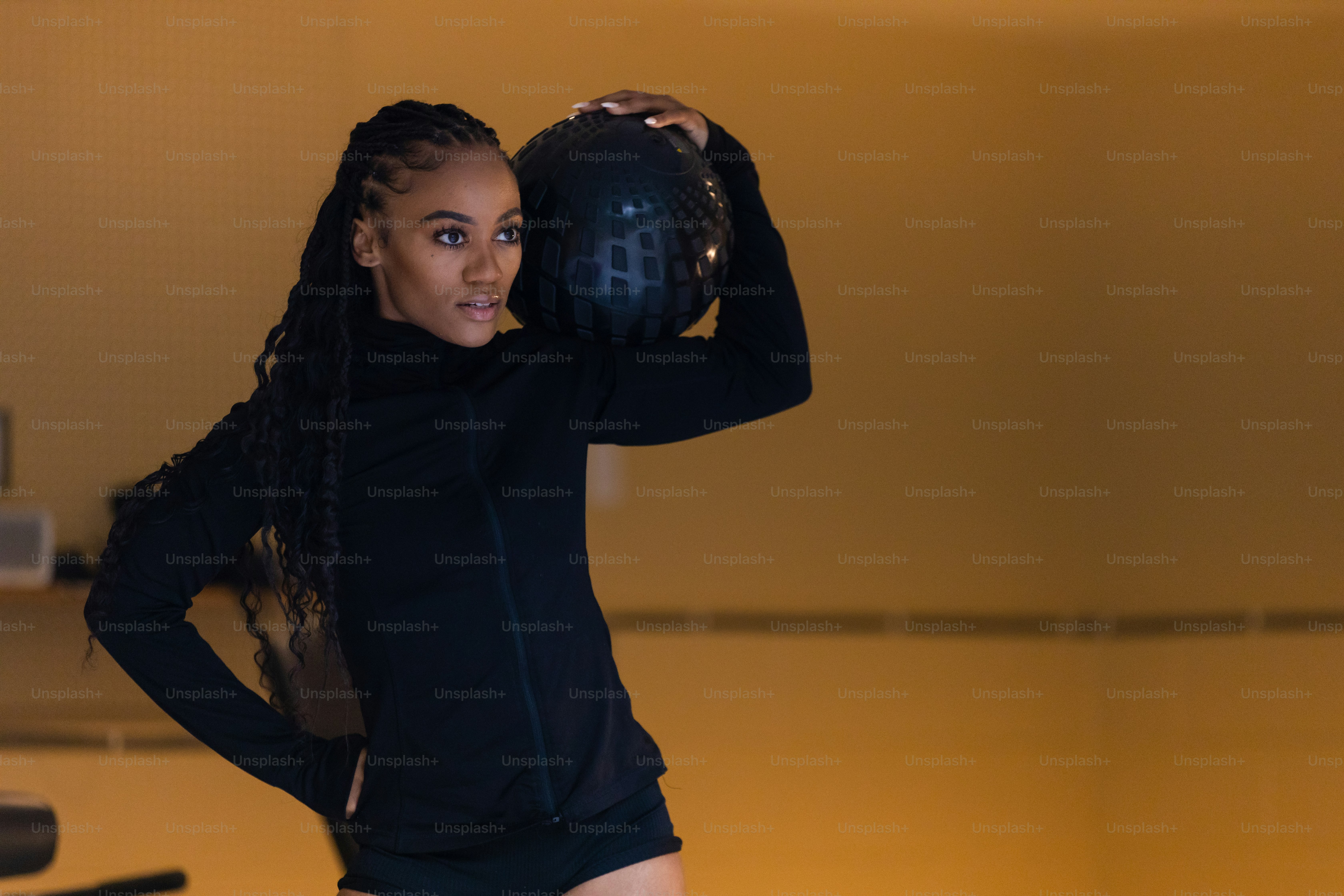 a woman holding a bowling ball and posing for a picture