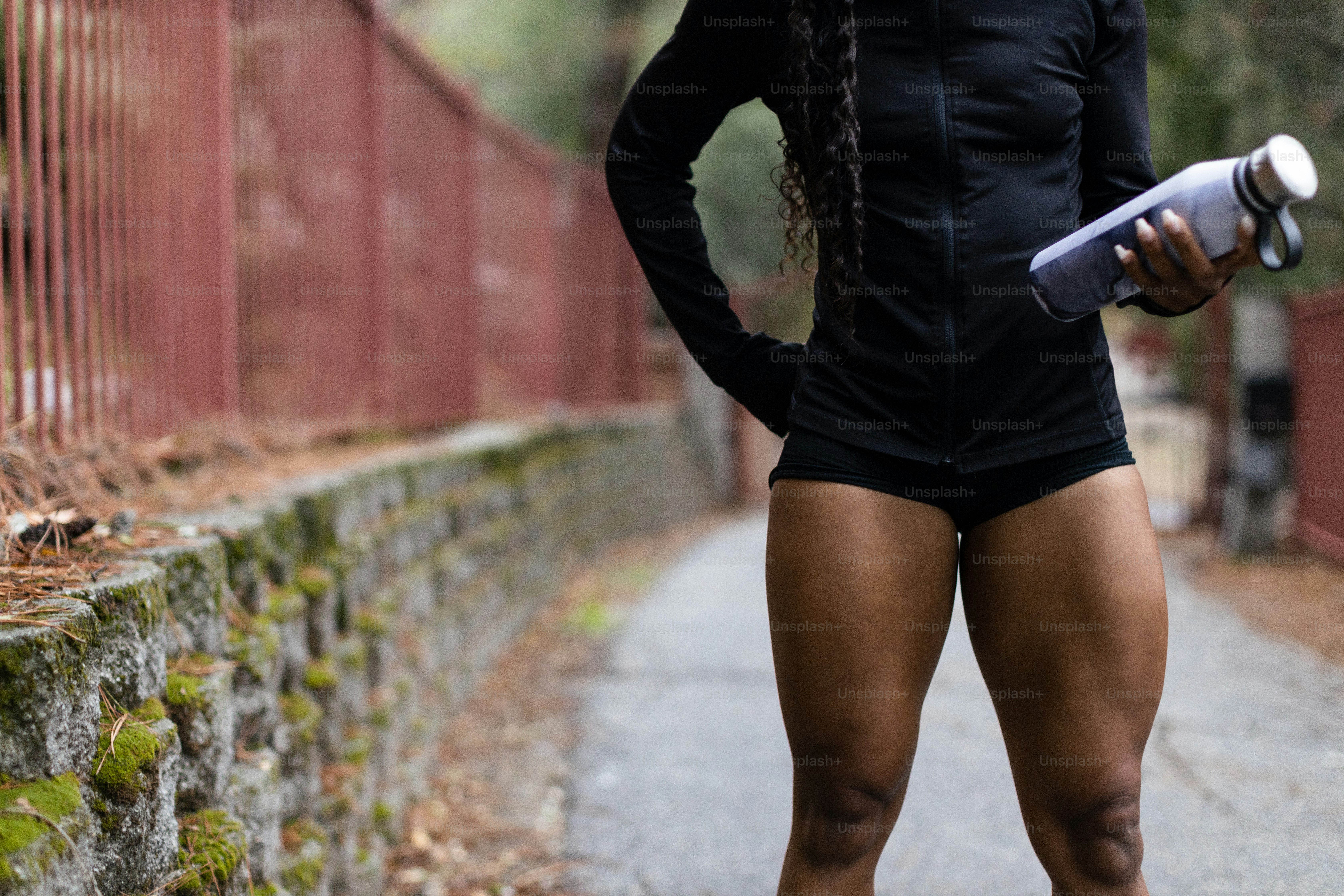 Athlete using percussion massage tools on tight calf muscles after marathon training run