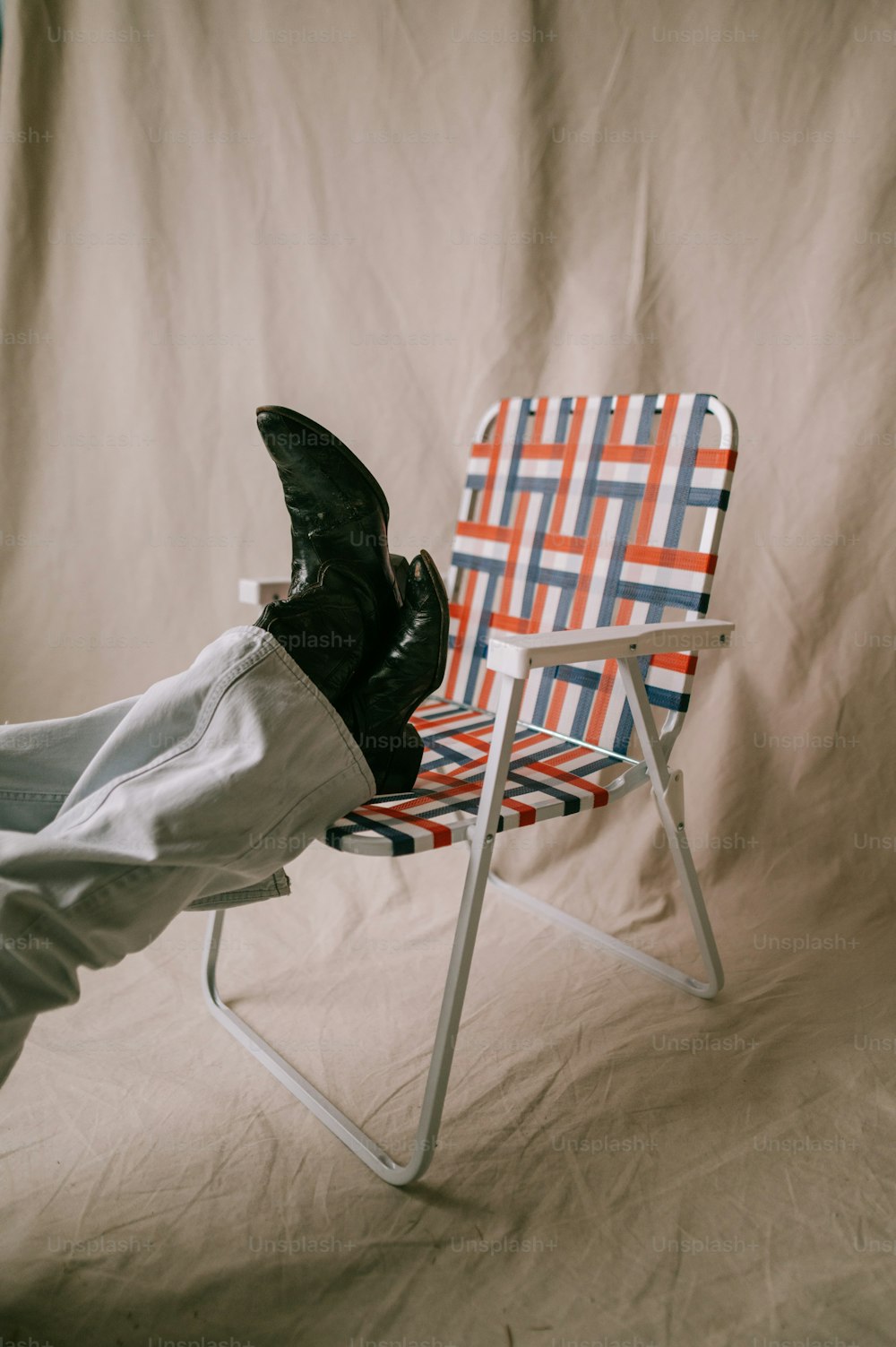 a person laying on a chair with their feet up