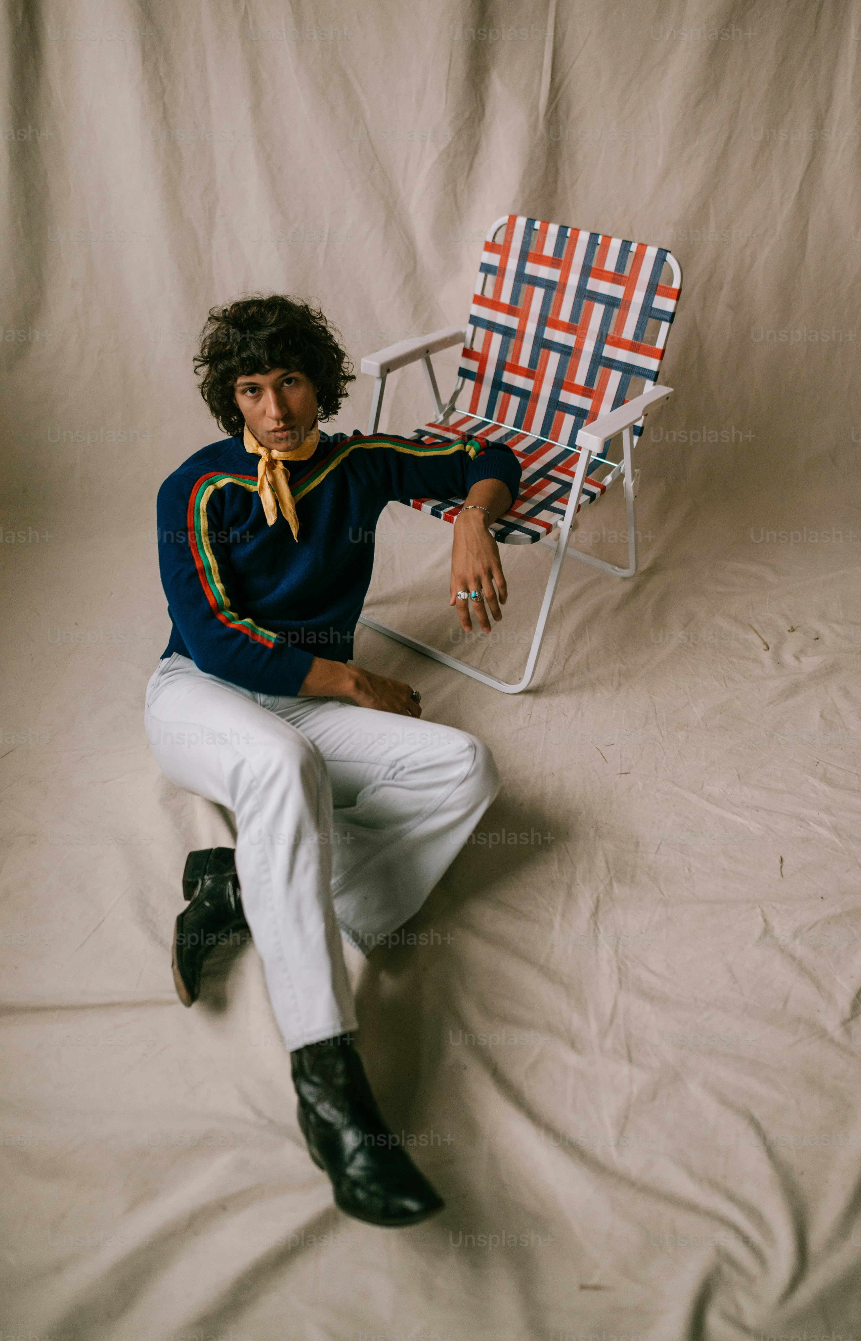 a man sitting in a chair with a tie on