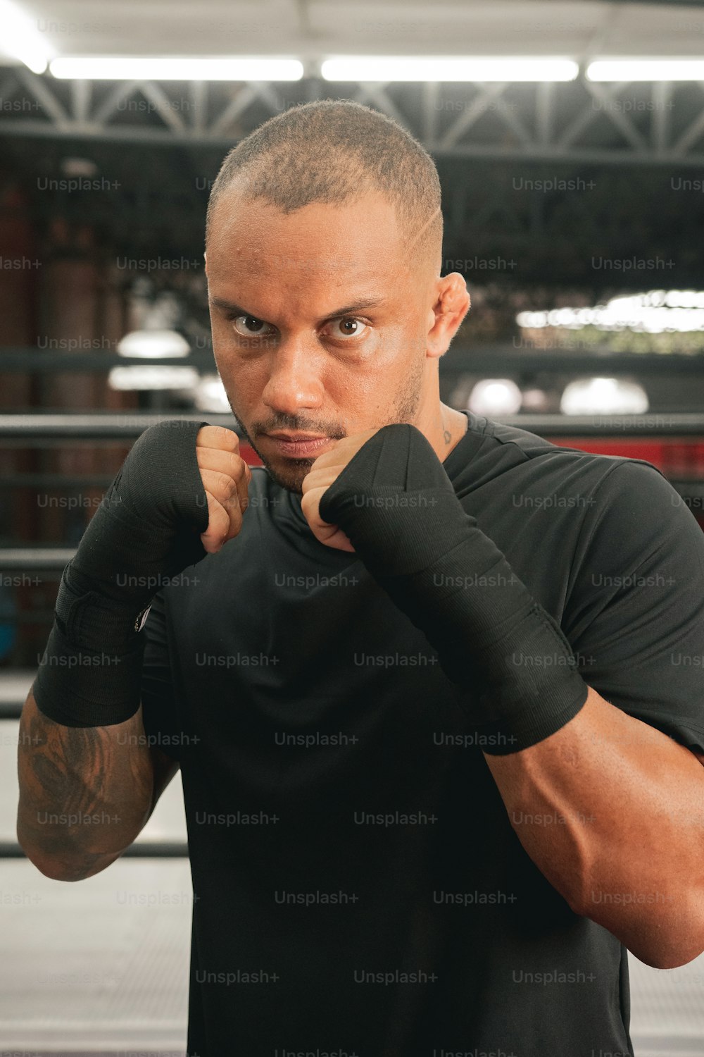a man wearing a black shirt and boxing gloves
