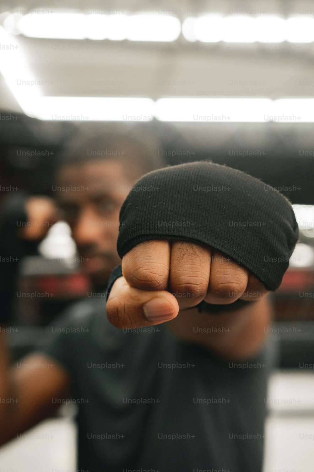 a man in a black shirt pointing a finger at the camera