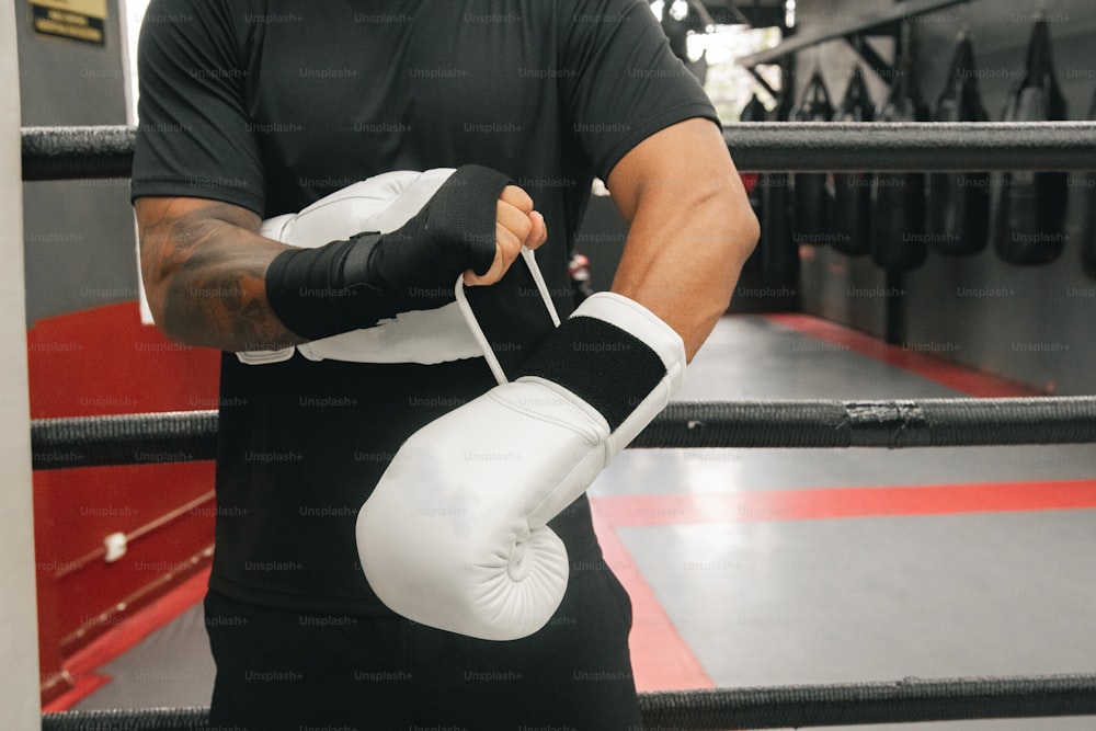 a man in a boxing ring holding a boxing glove
