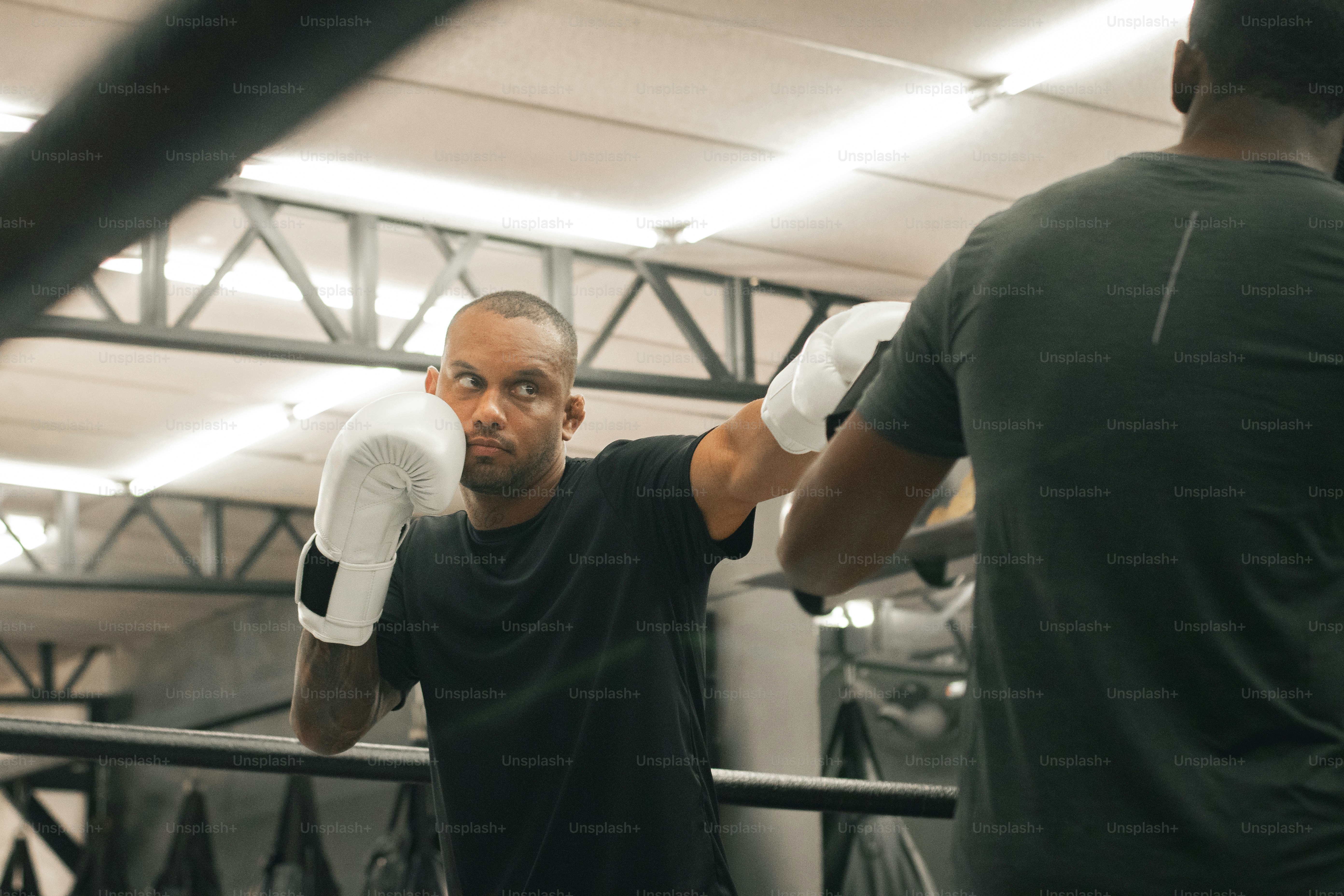 a man in a black shirt and white gloves