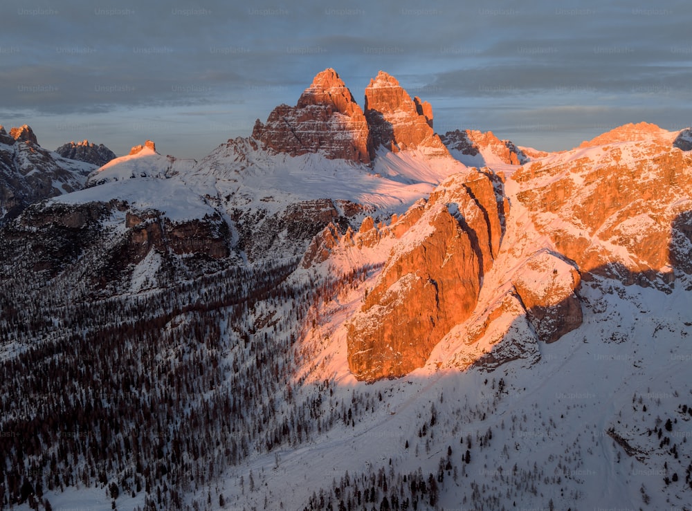 the sun is setting on a mountain range