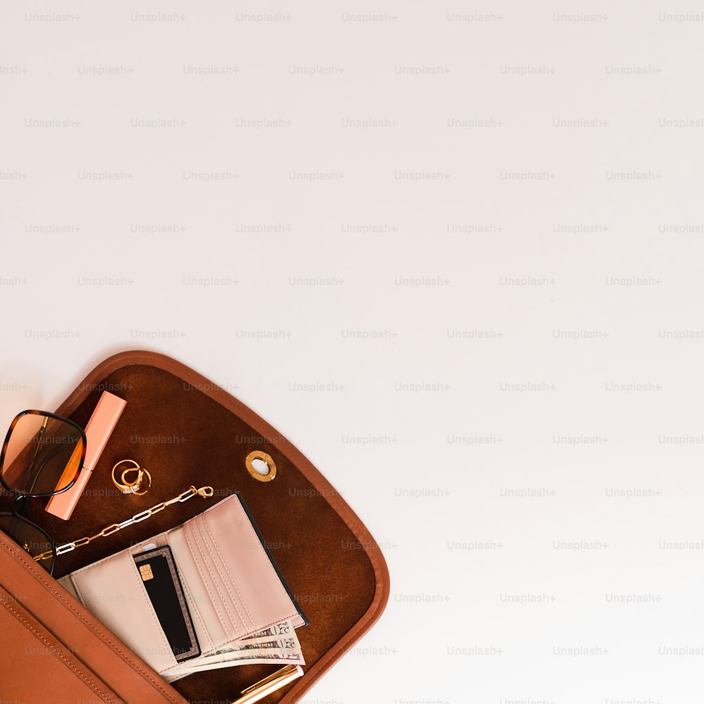 a brown case with a pair of glasses and a book