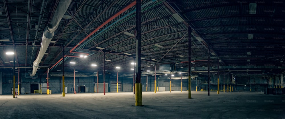 an empty warehouse with lights on the ceiling