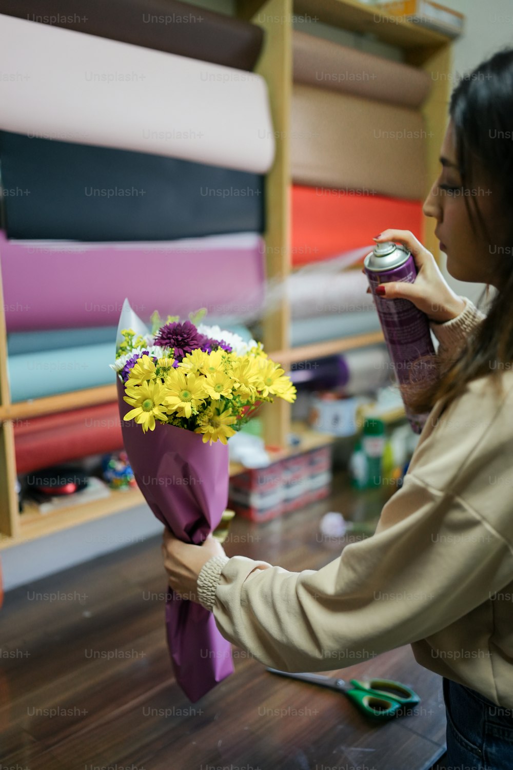 a woman is holding a bouquet of flowers