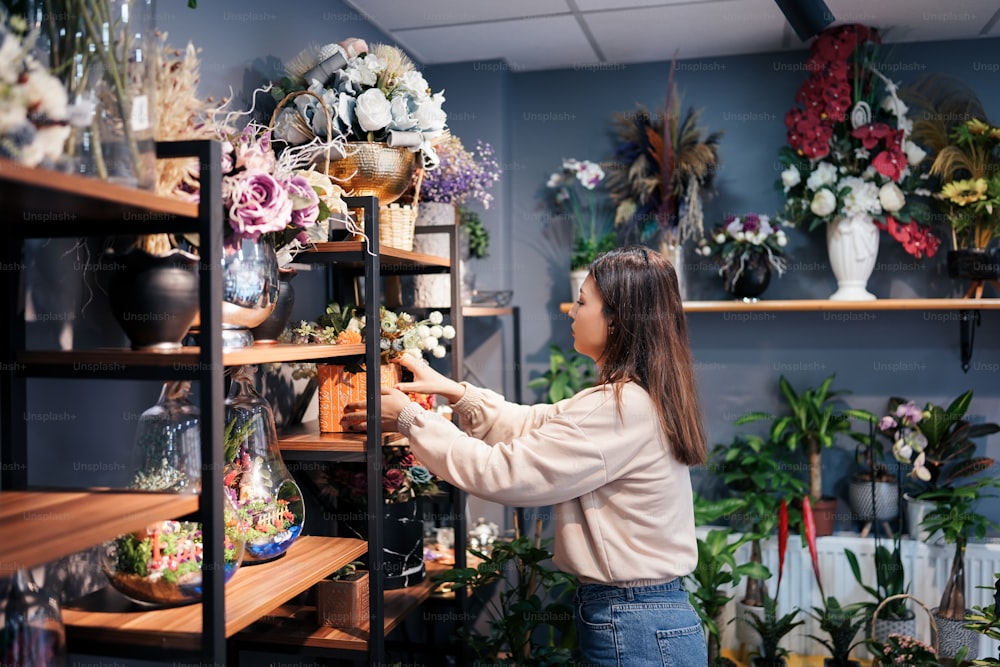 a woman arranging flowers in a flower shop