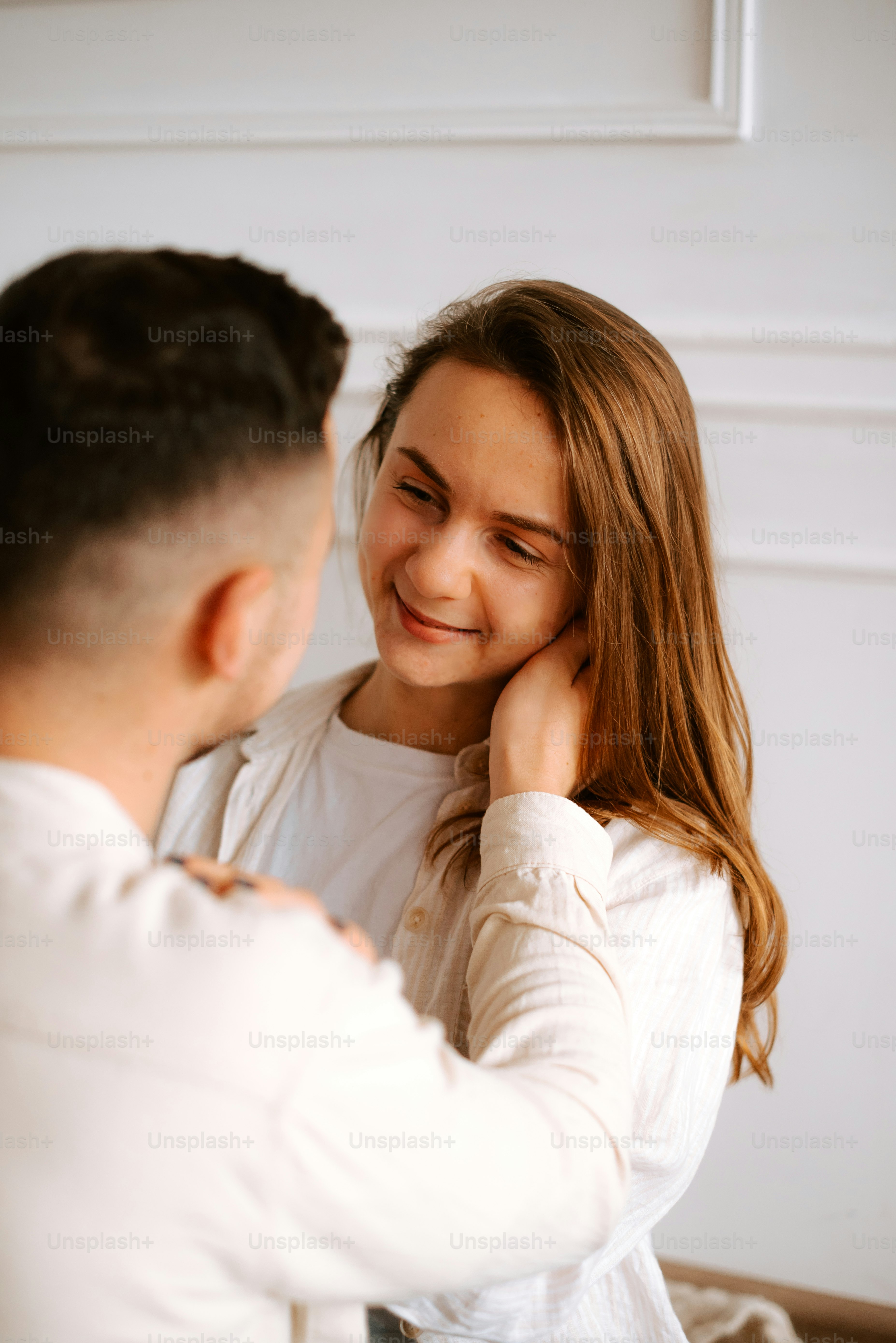a man and a woman smiling at each other