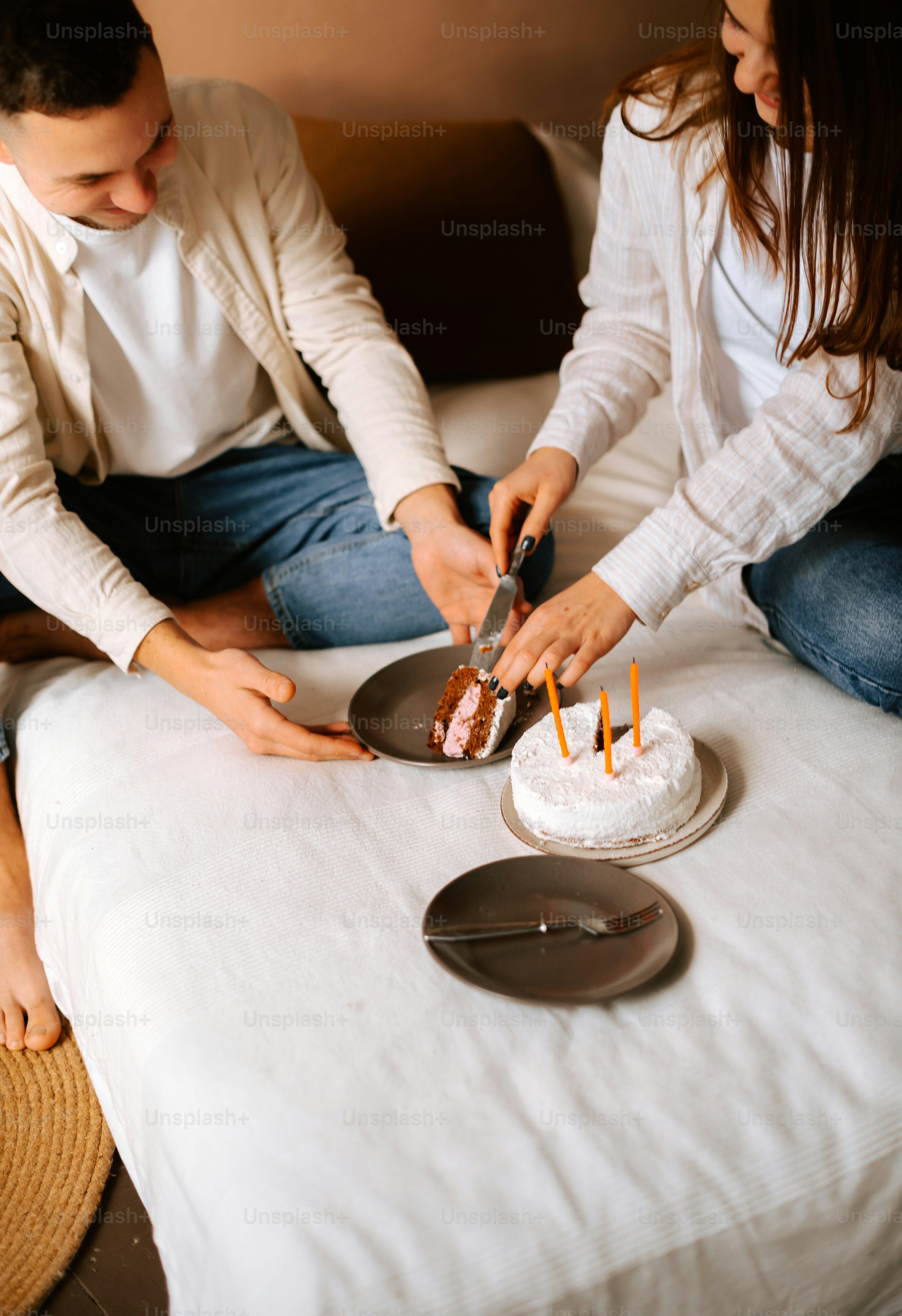 a man and woman cutting a cake together