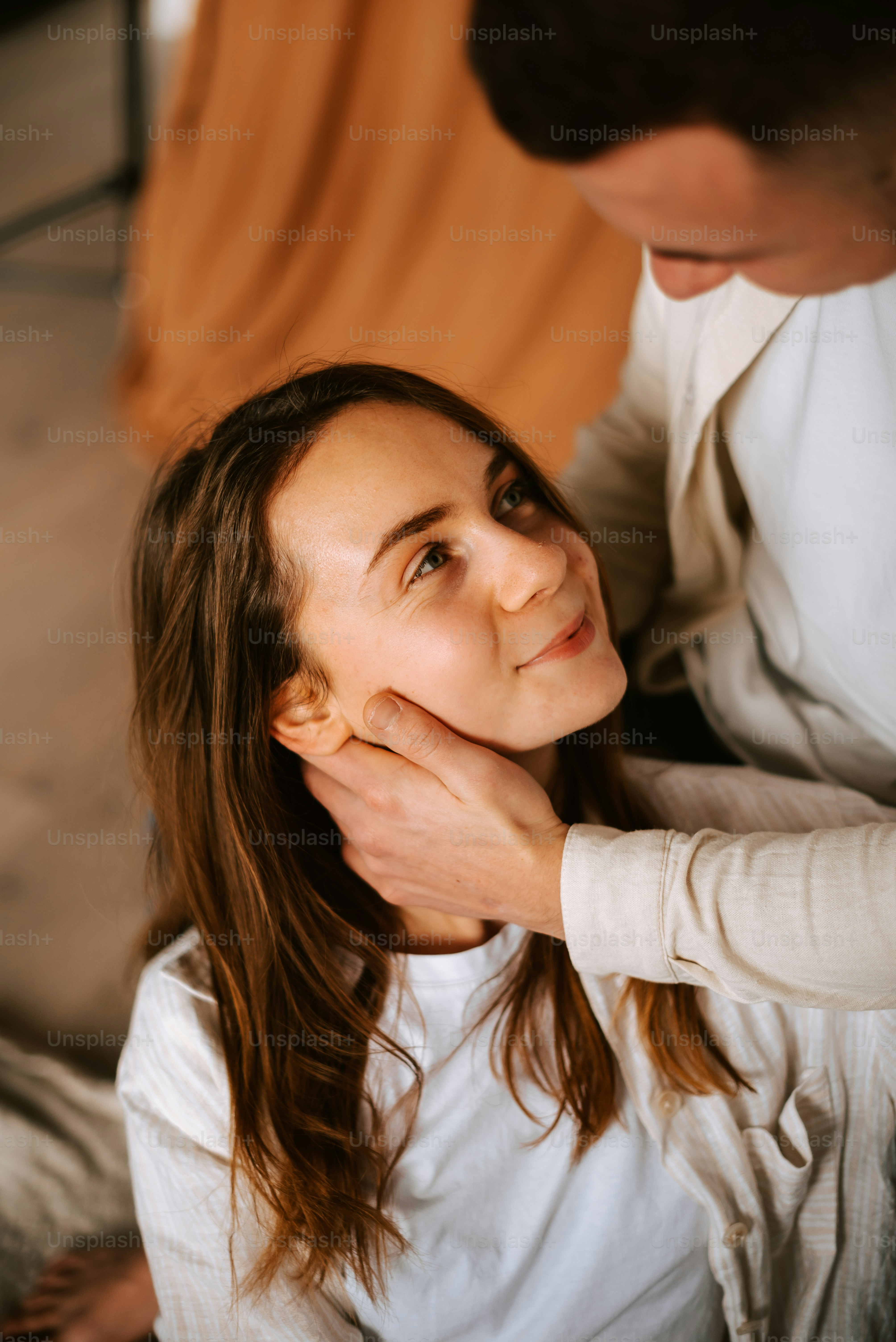 a woman getting her hair styled by a man