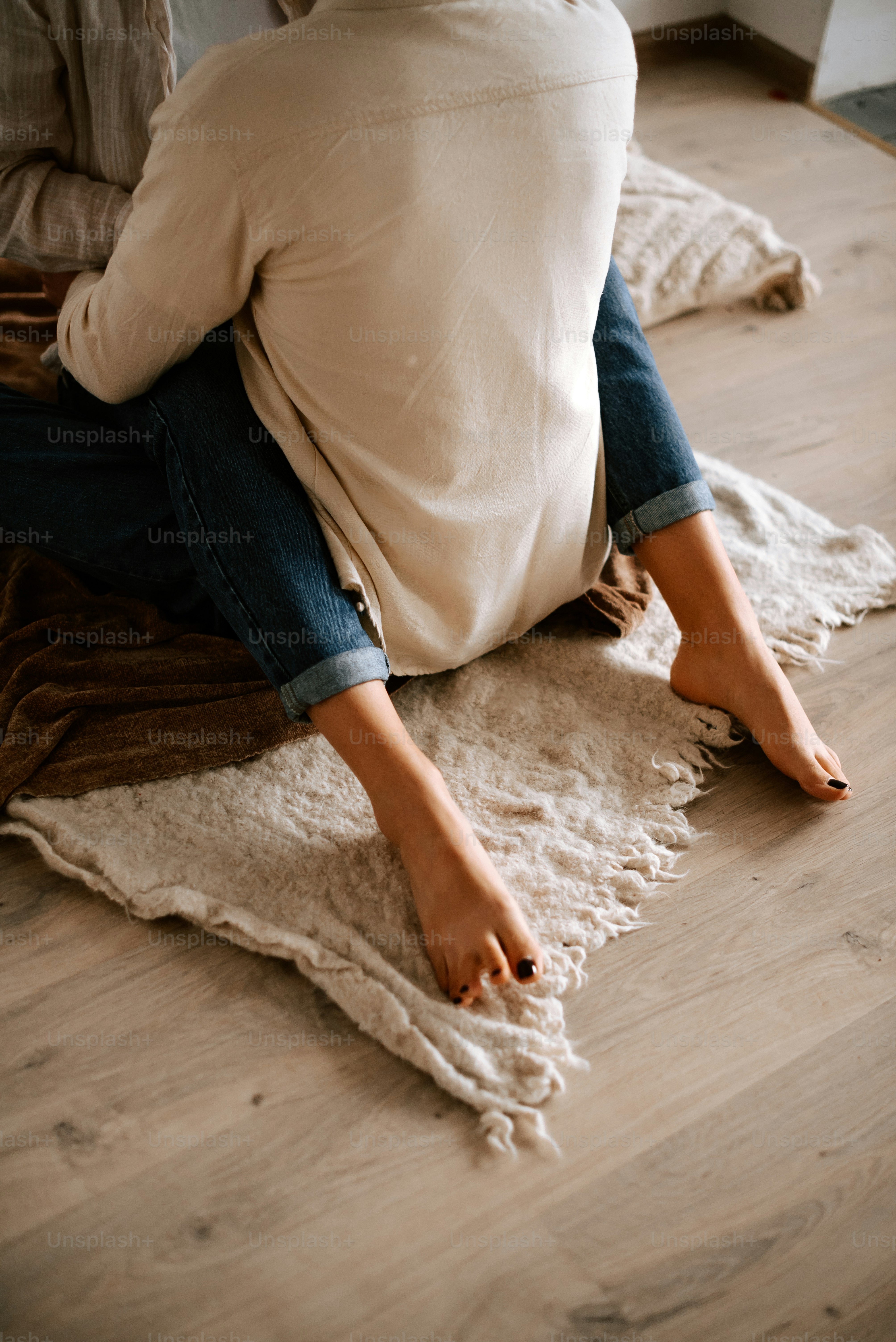 a woman sitting on the floor with her legs crossed