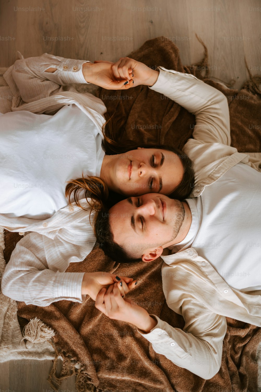 a man and a woman laying on a bed