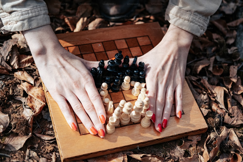 a woman playing a game of chess on a board