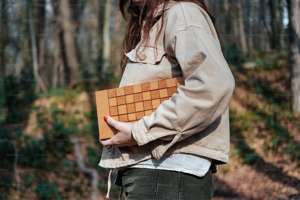 a woman holding a piece of wood in her hands