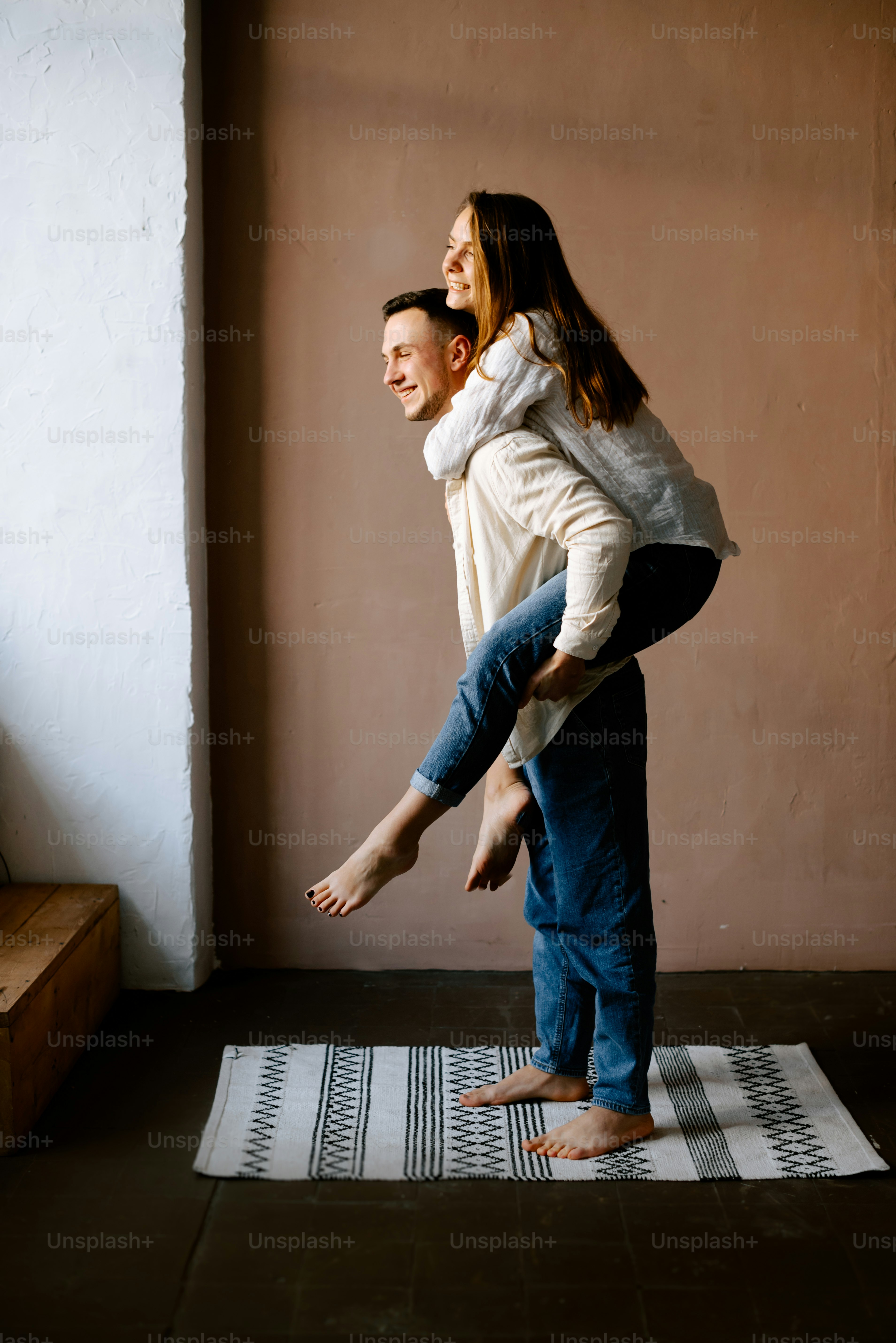 a man and a woman standing on a rug