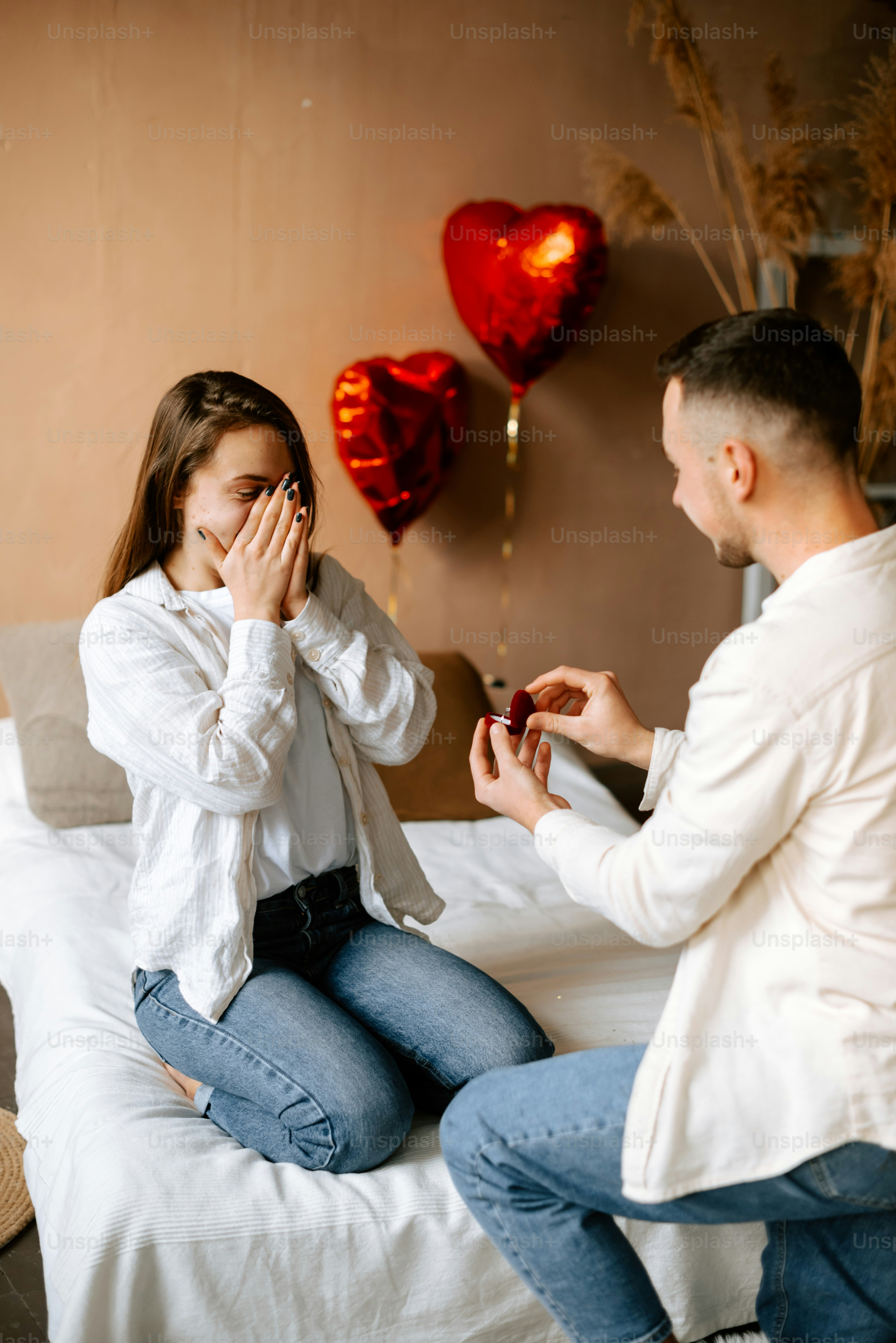 a man and a woman sitting on a bed