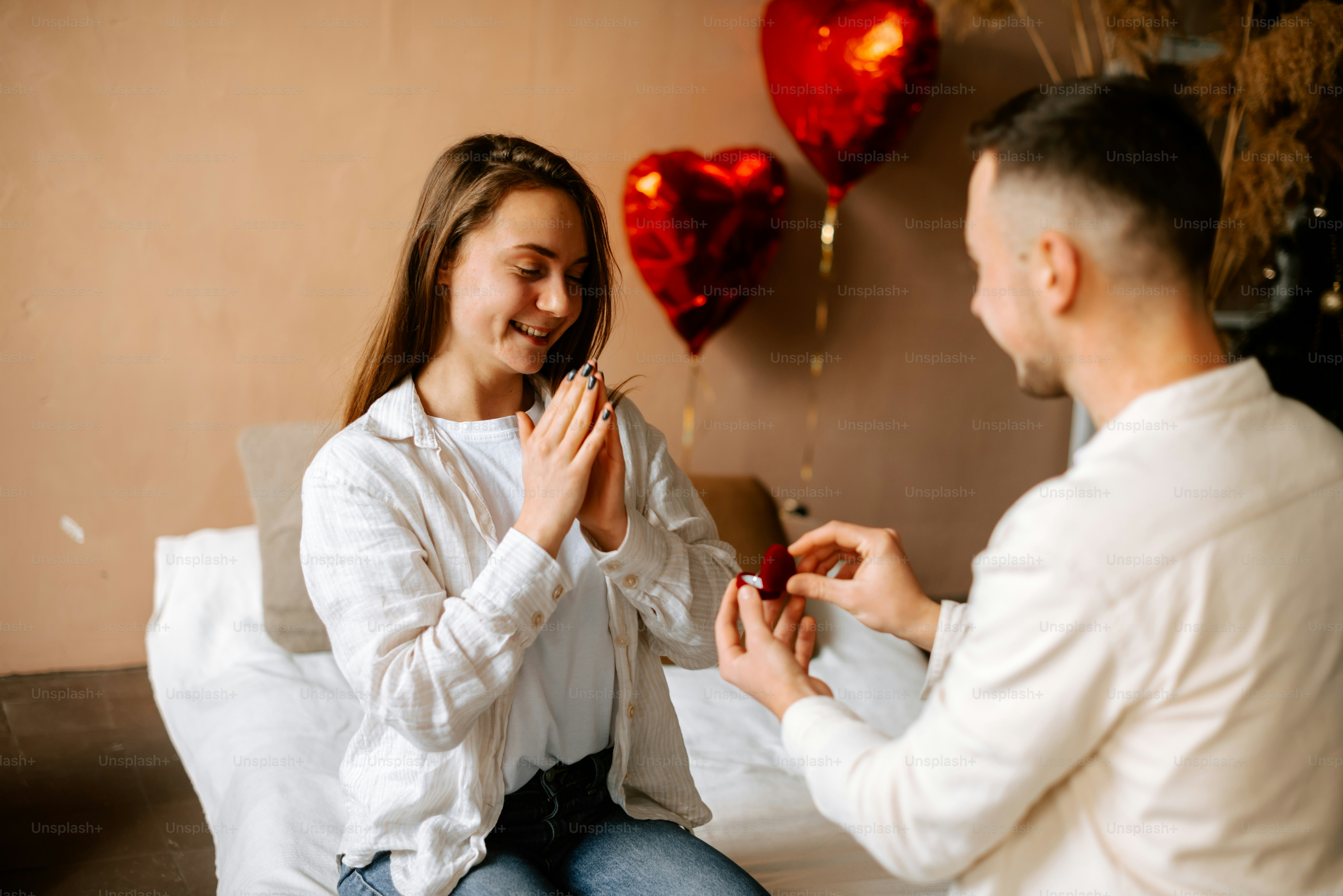 a man and a woman sitting on a bed