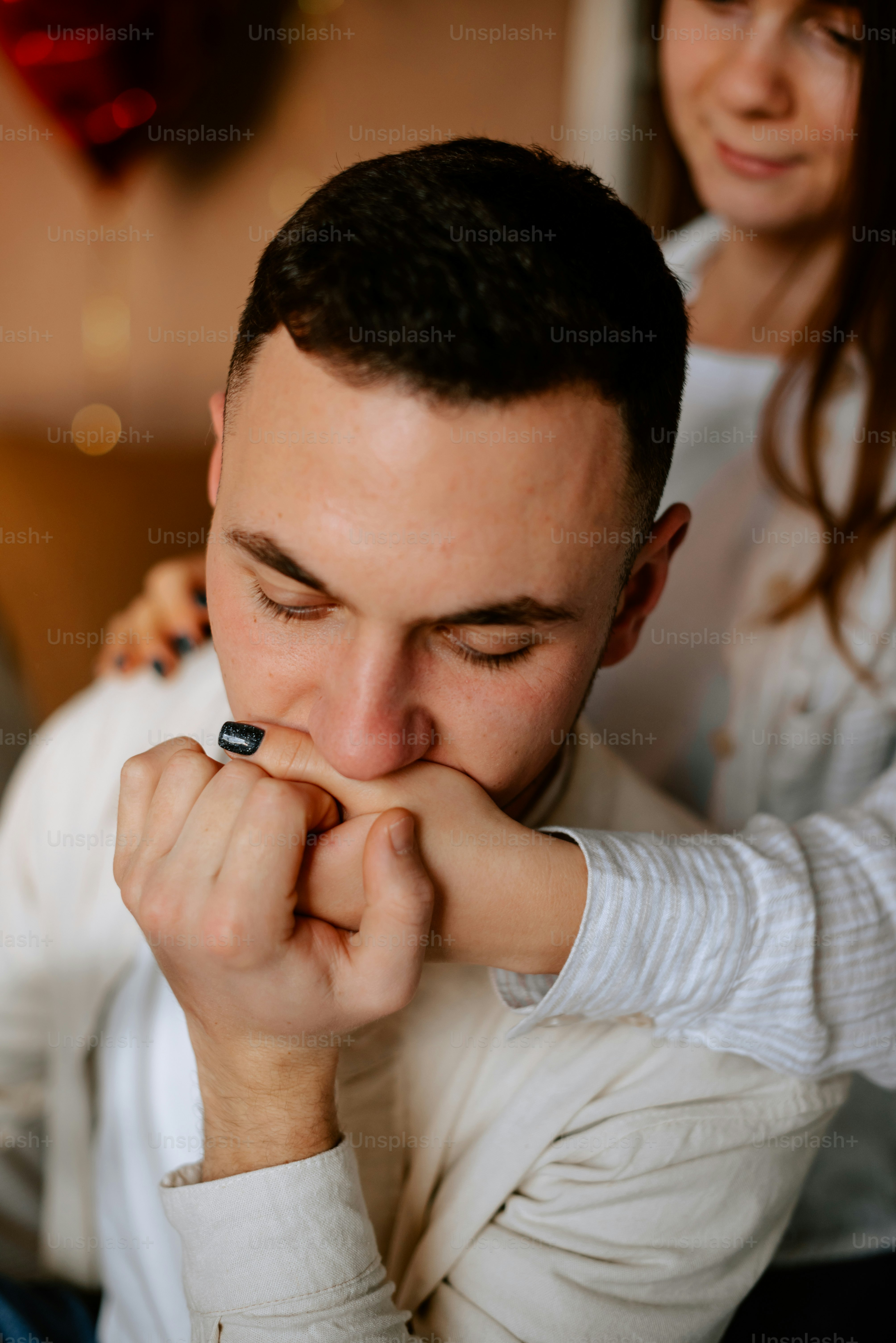 a man and a woman are looking at a cell phone