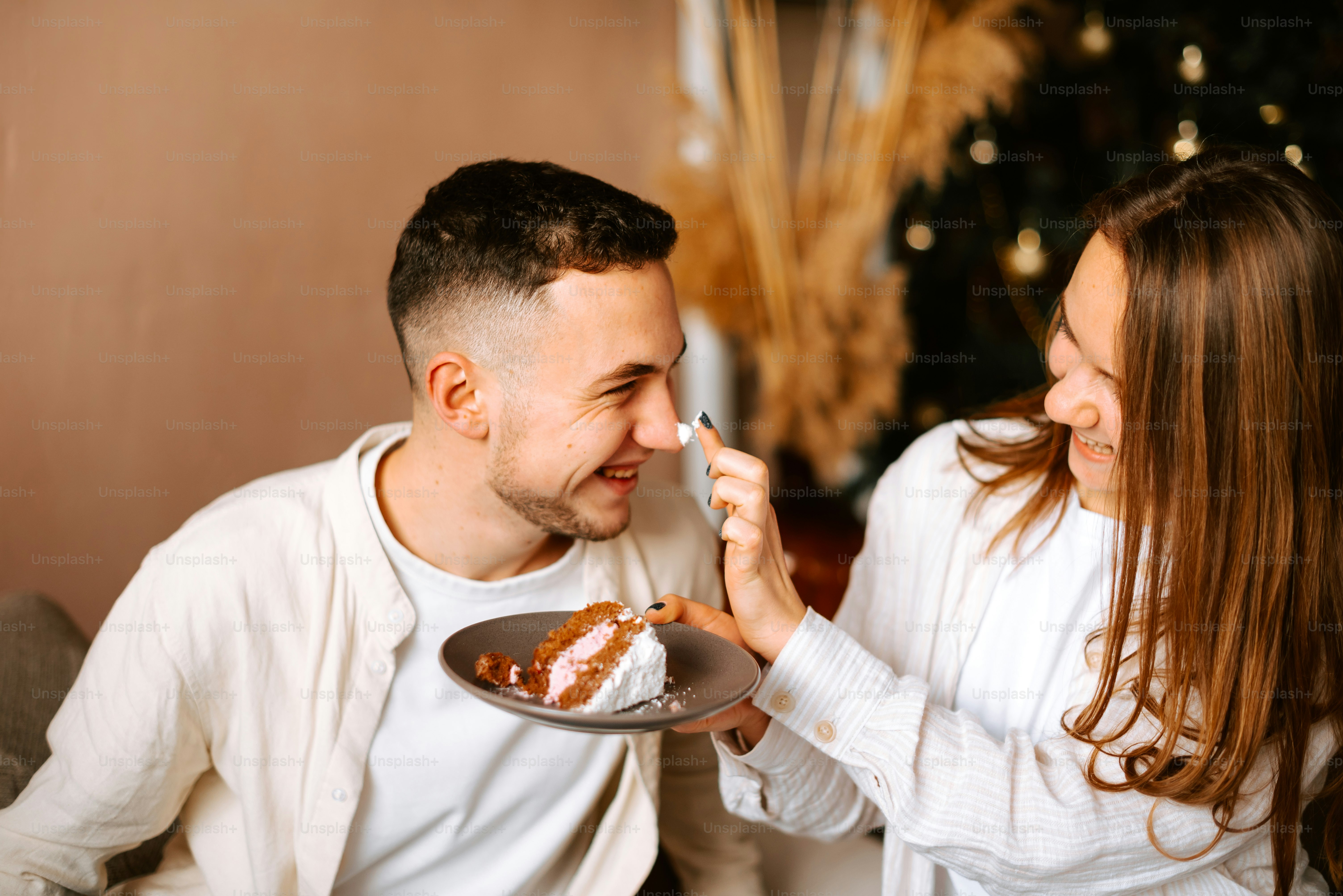 a man feeding a woman a piece of cake