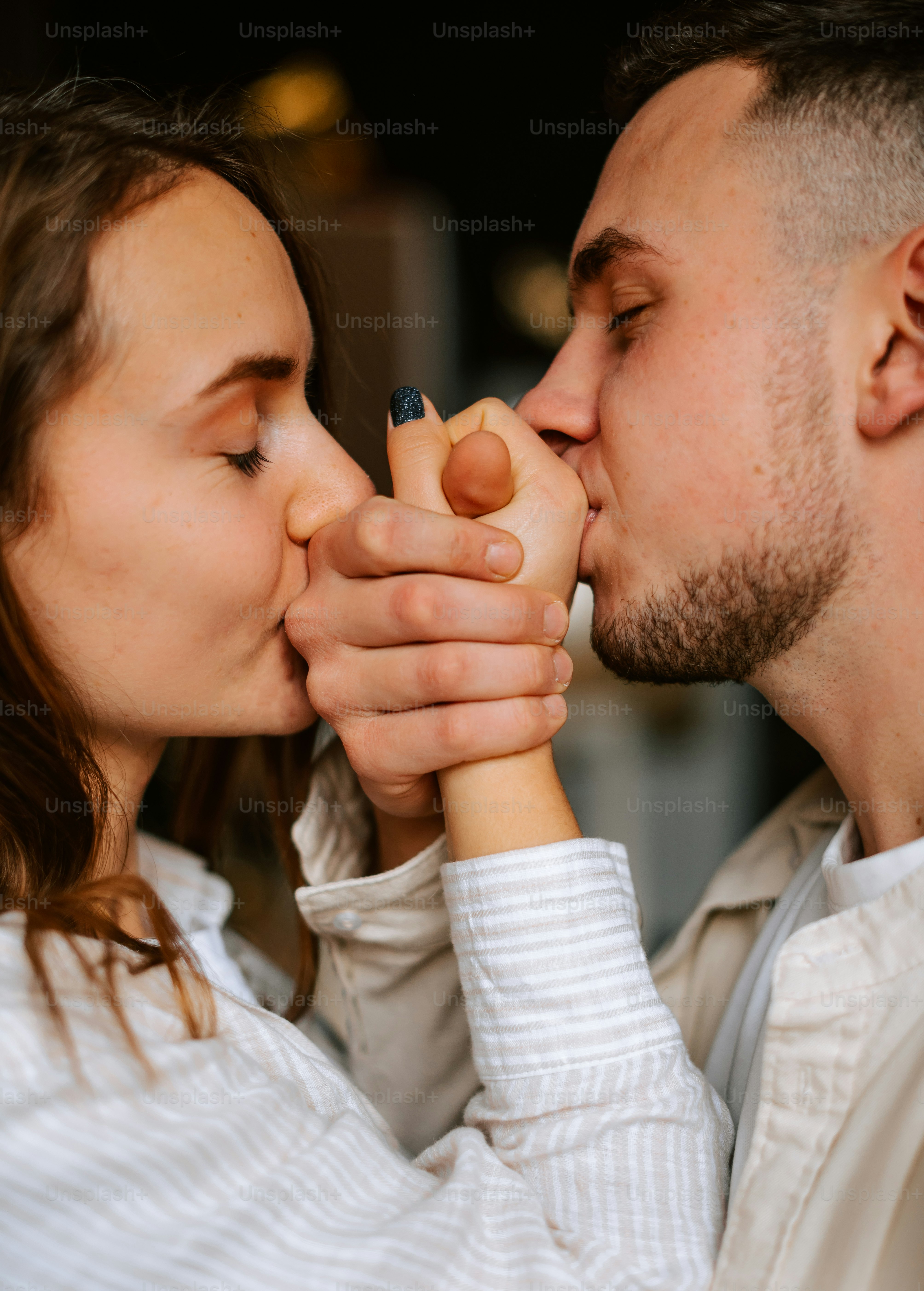 a man and a woman kissing each other