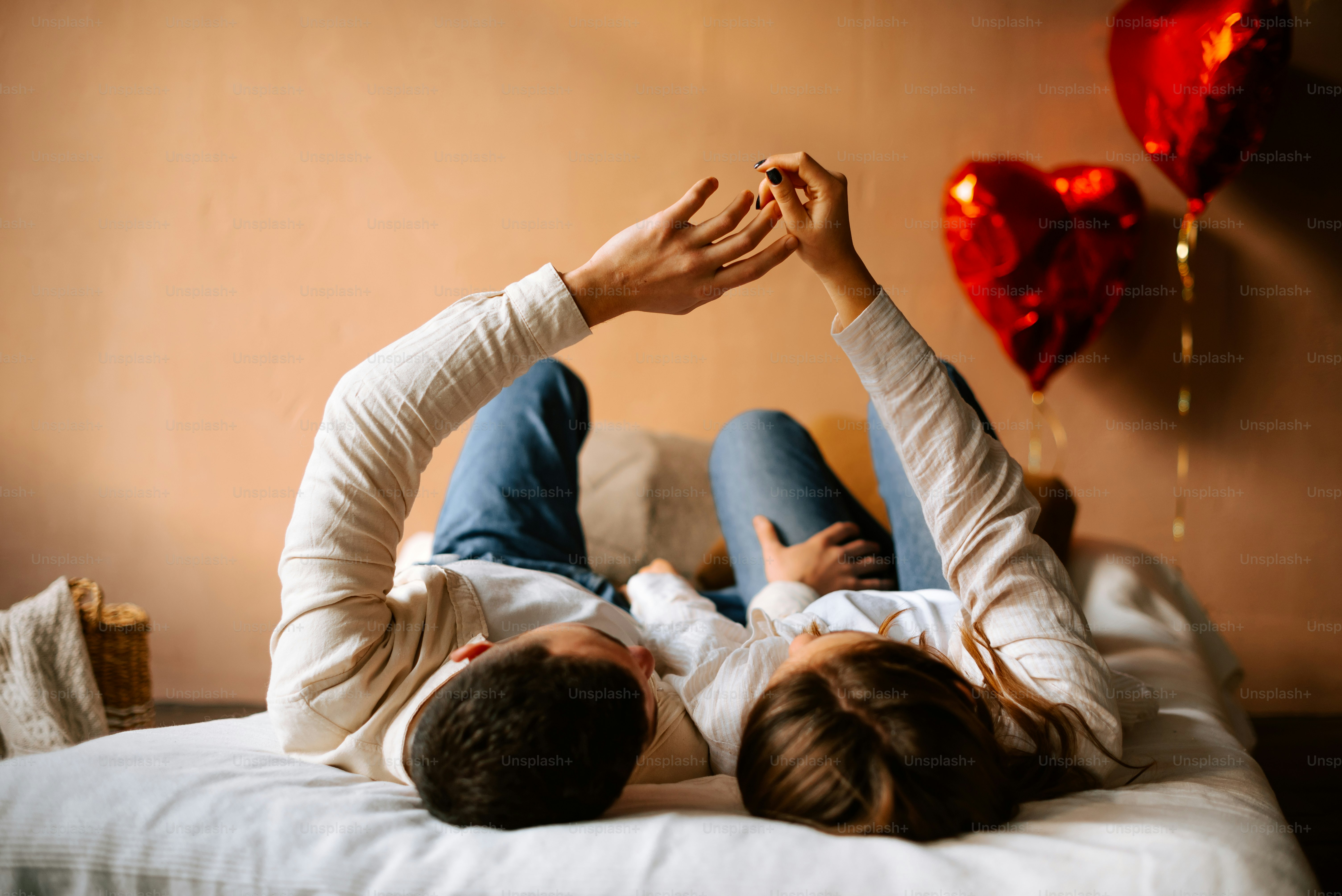 a man and a woman laying on a bed