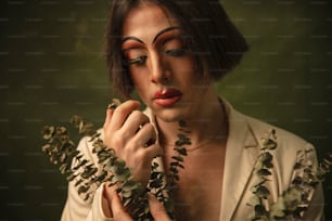 a woman is holding a bunch of leaves