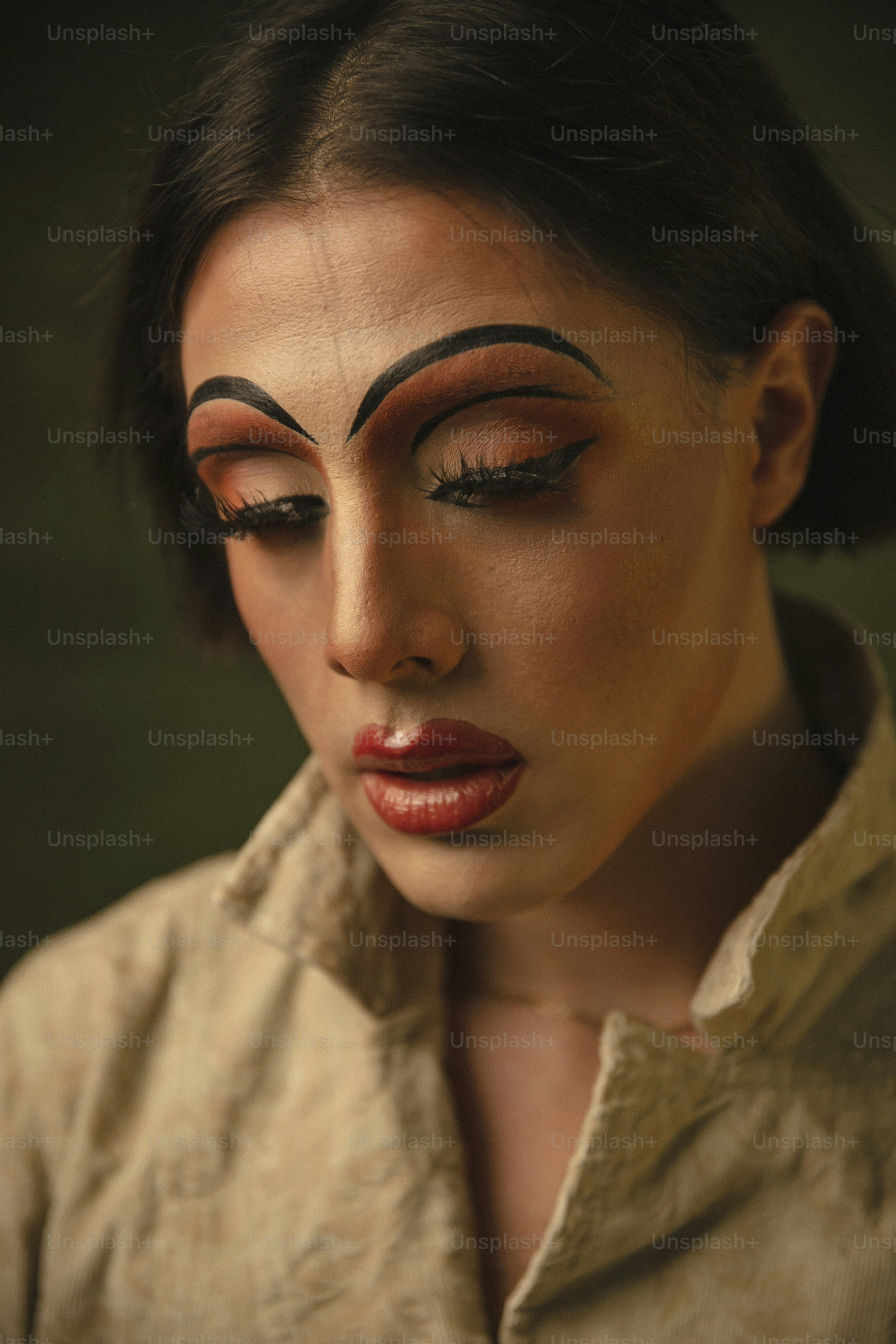 a woman with black eyebrows and red lipstick