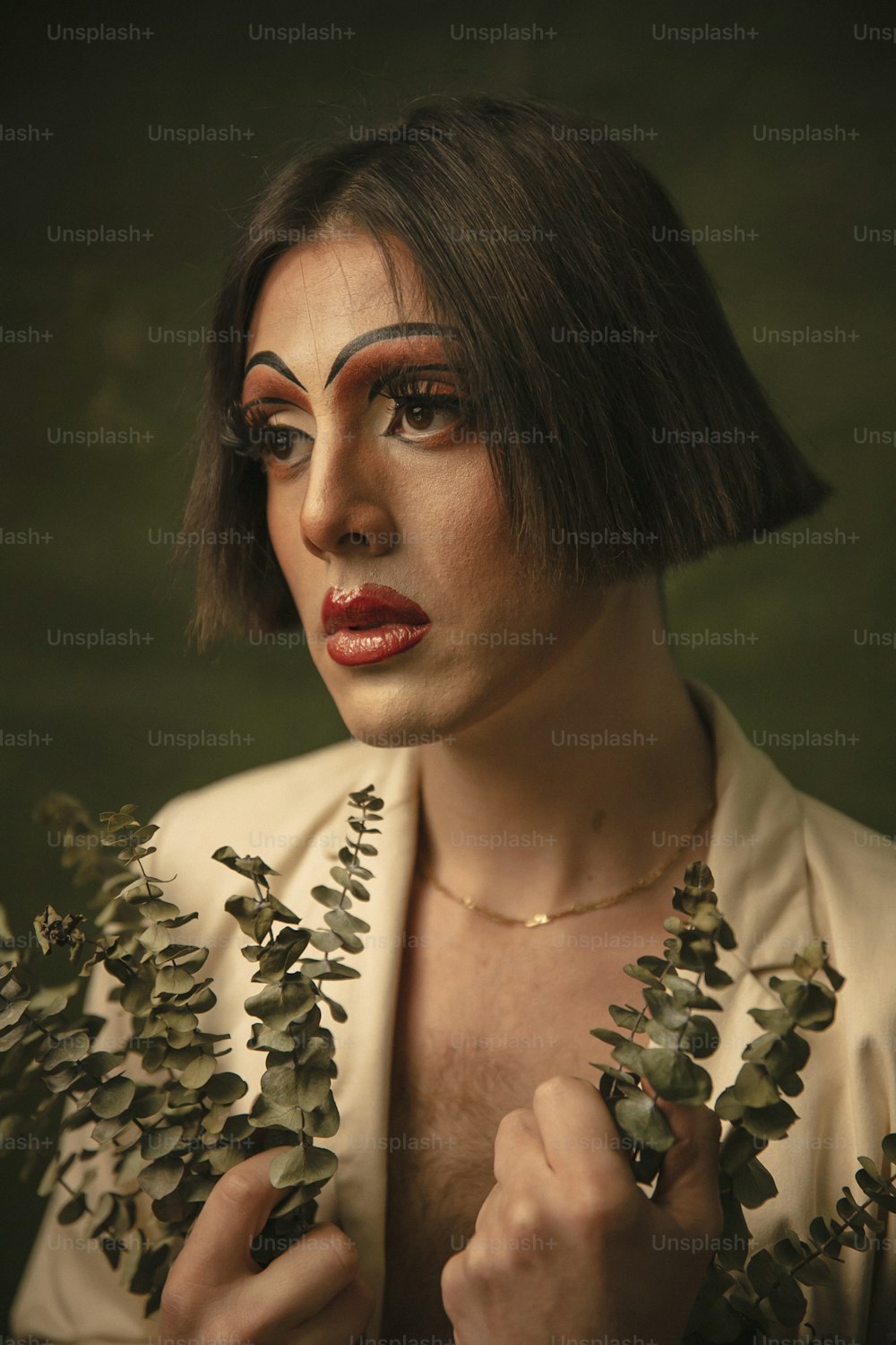a woman with makeup on her face holding a plant