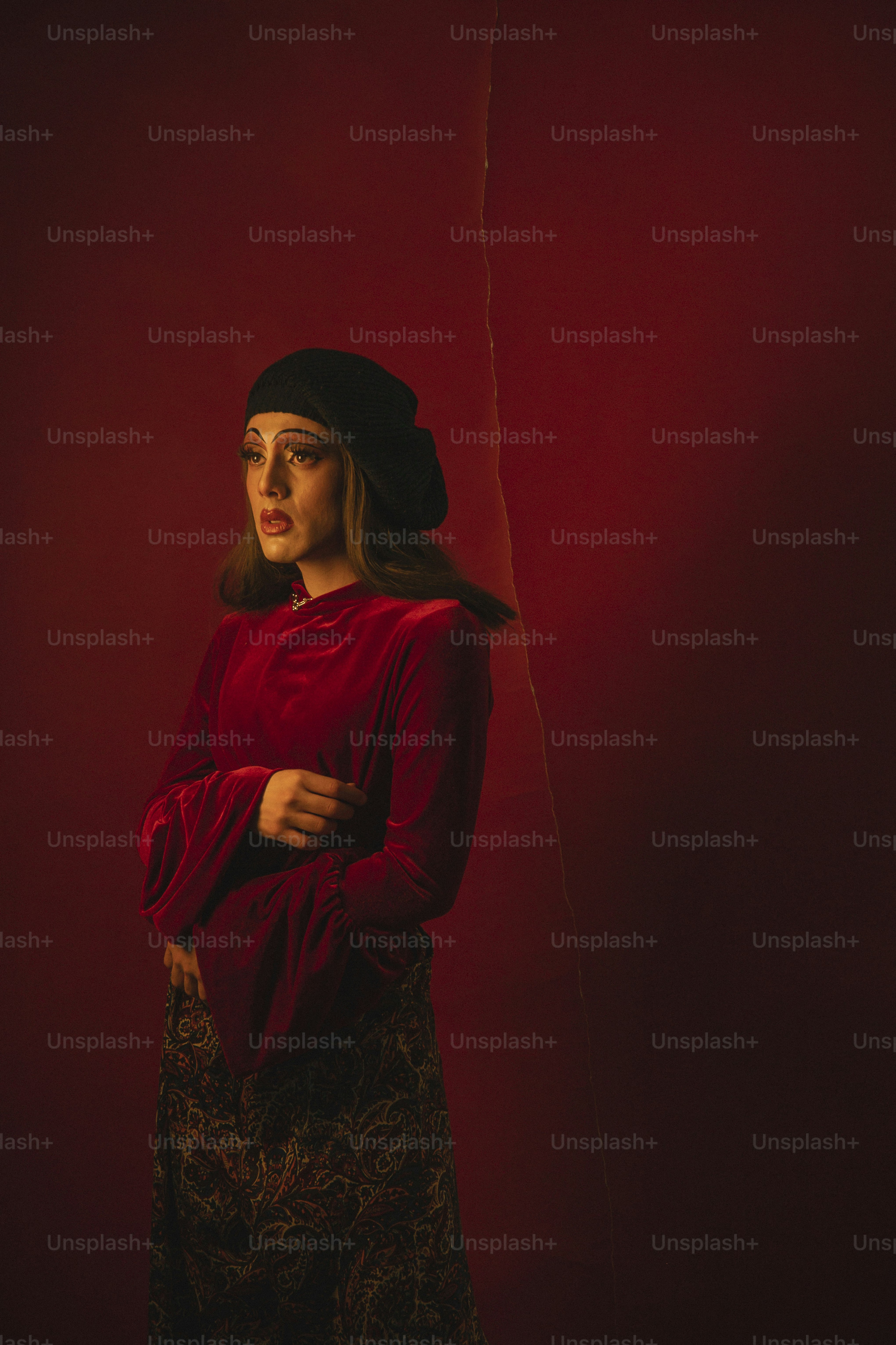 a woman in a red shirt and a black hat