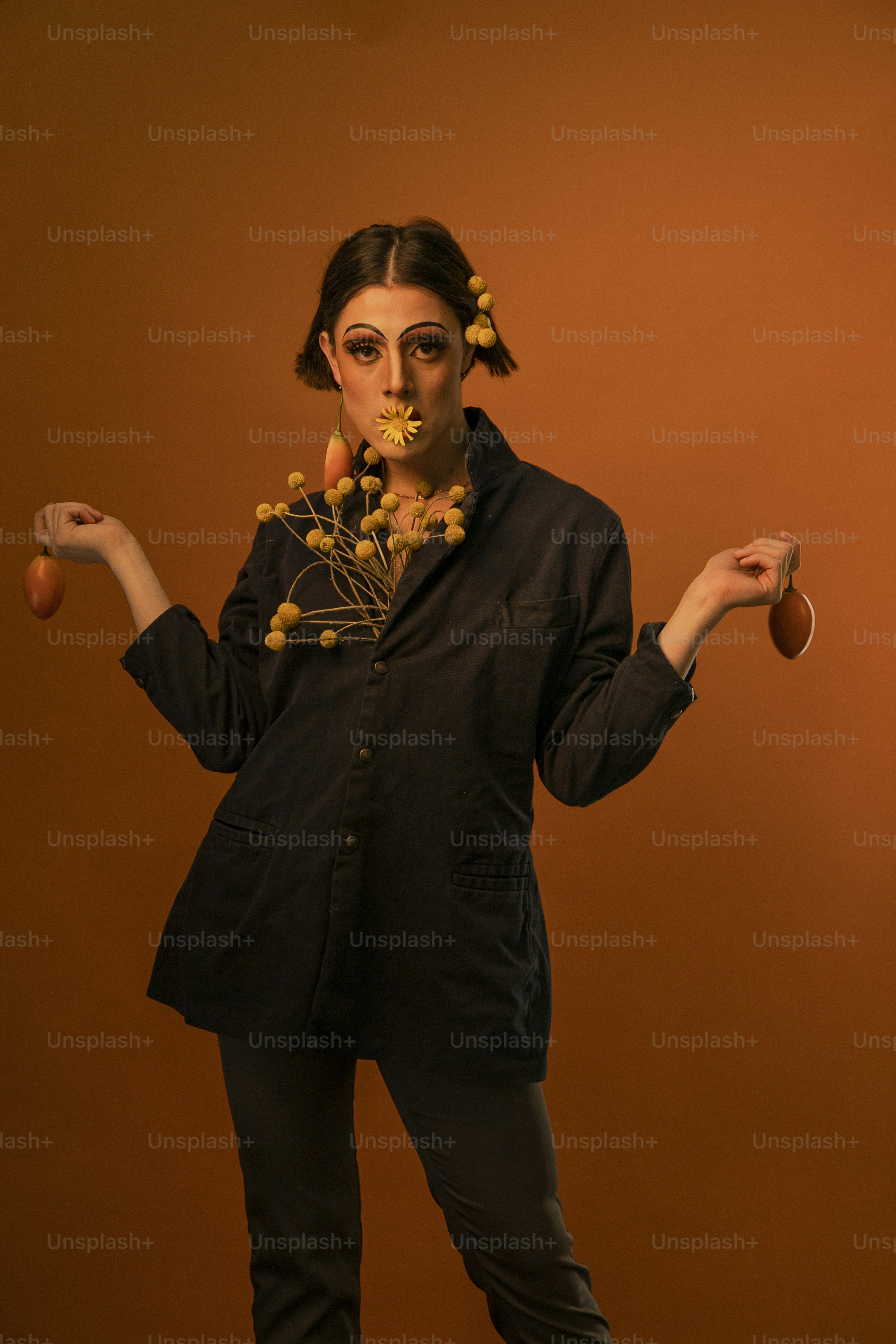 a woman in a black suit with flowers in her hair