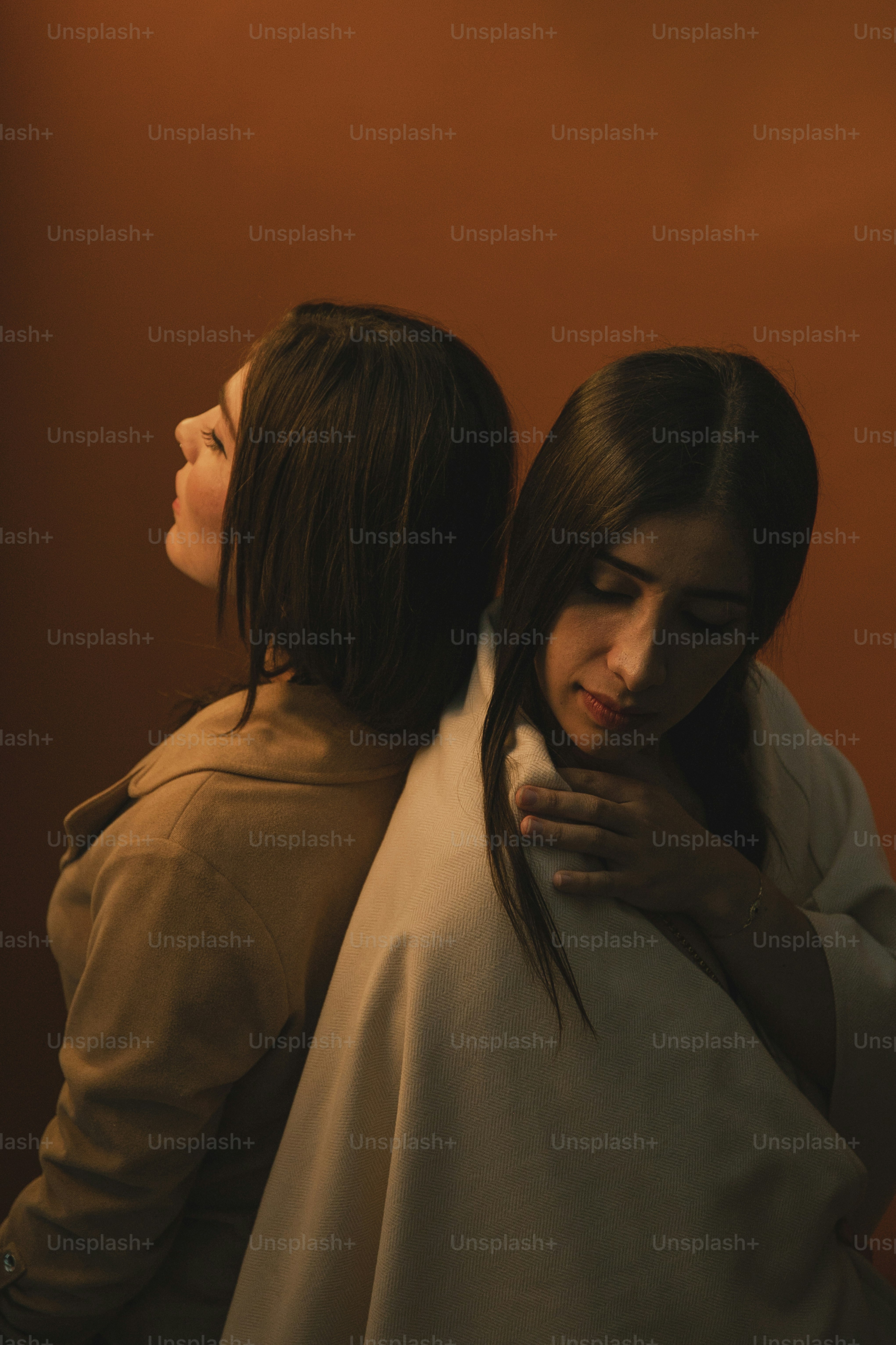 two women standing next to each other in a room