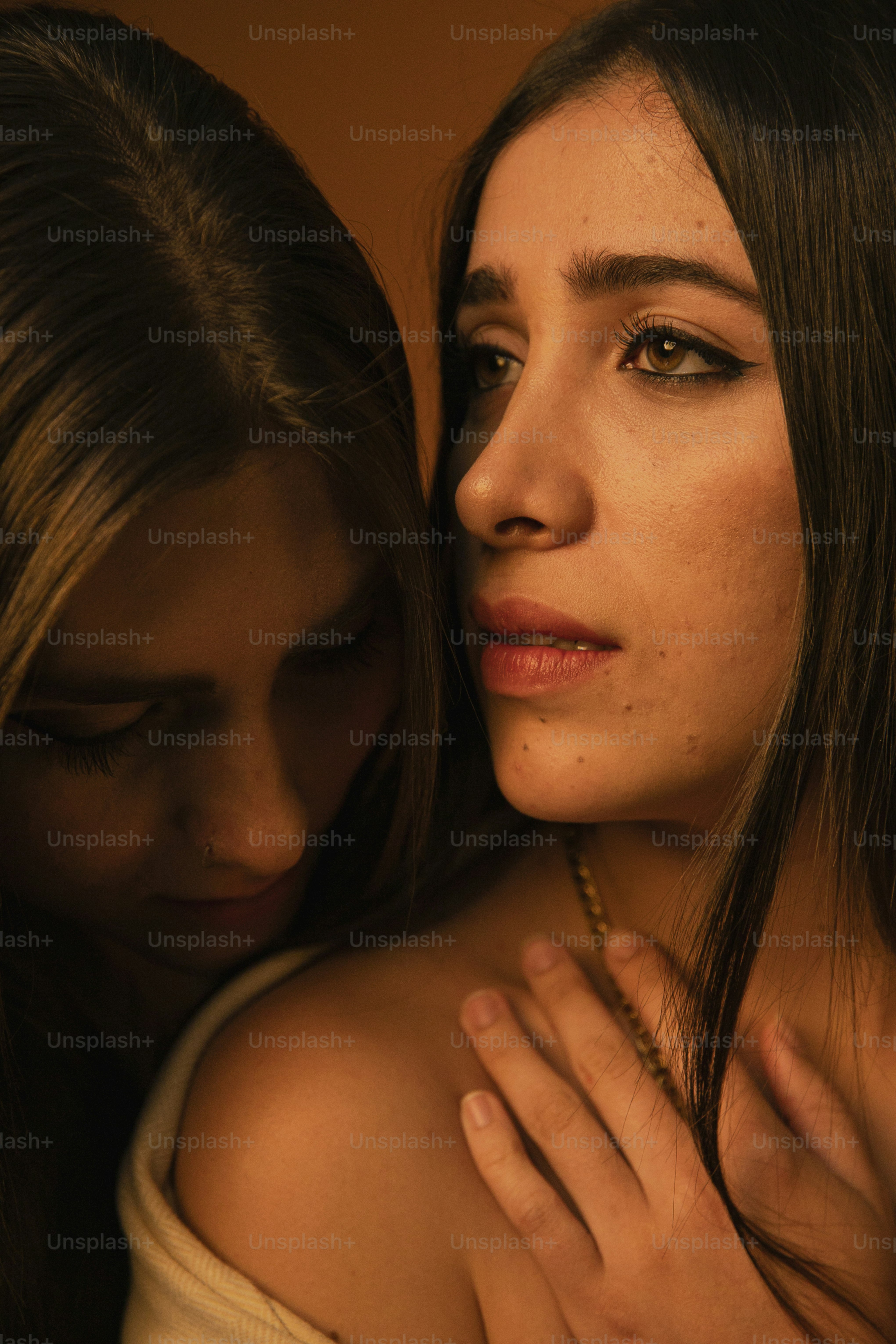 two beautiful young women embracing each other