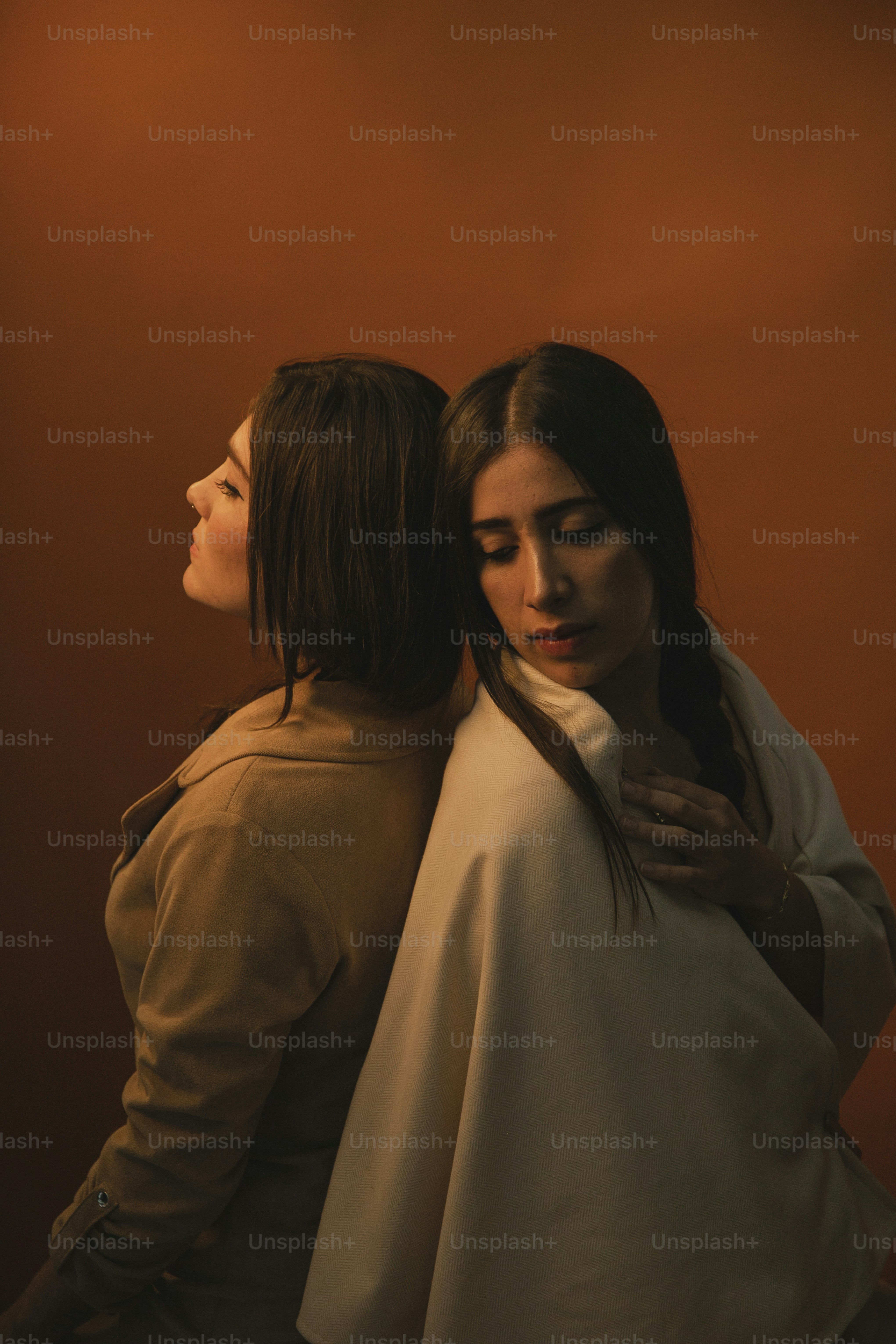 two women standing next to each other in a room