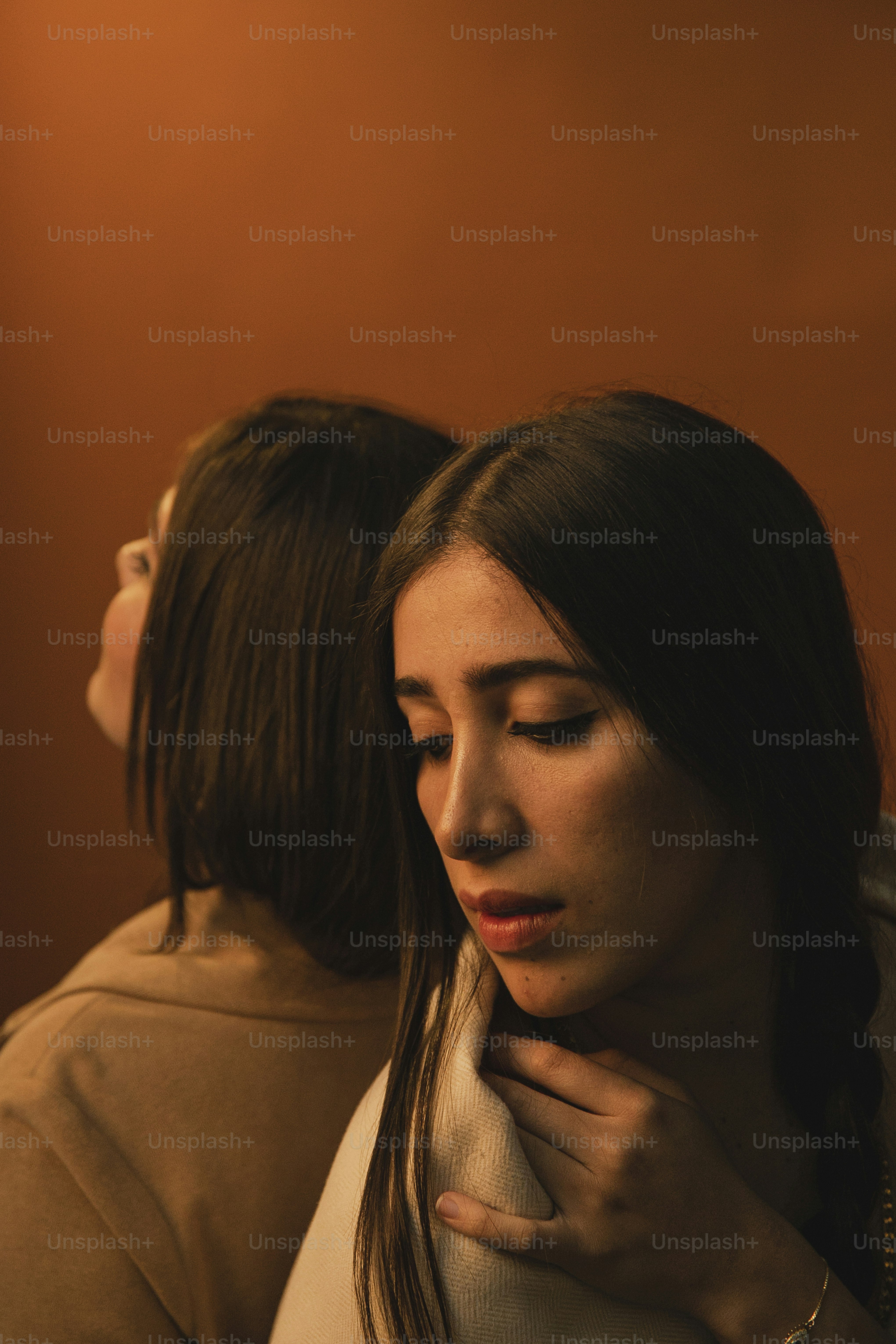 two women standing next to each other in a room