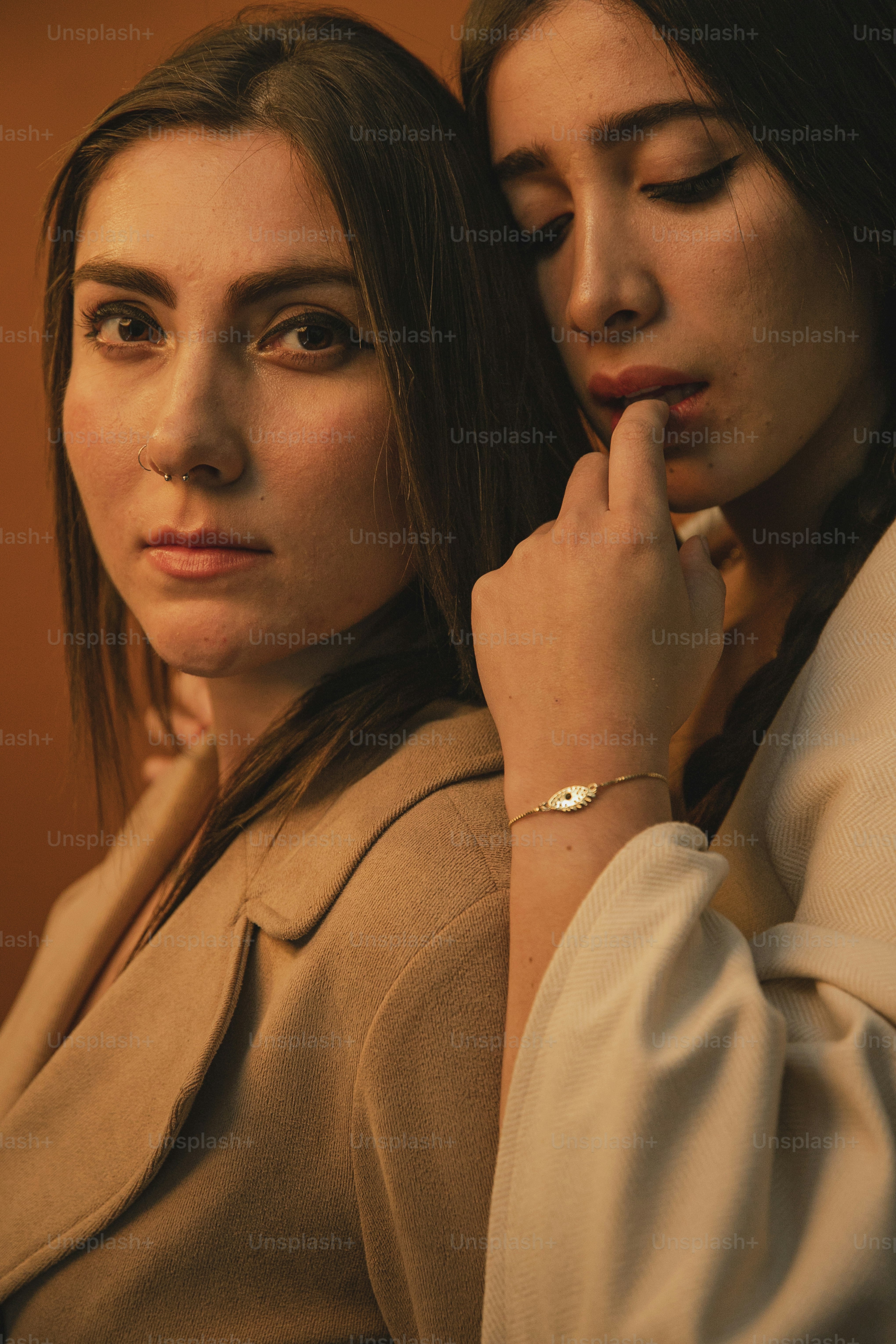 two beautiful young women standing next to each other