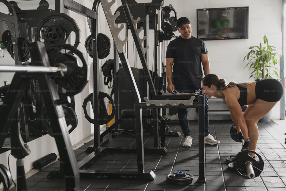 a man and a woman working out in a gym