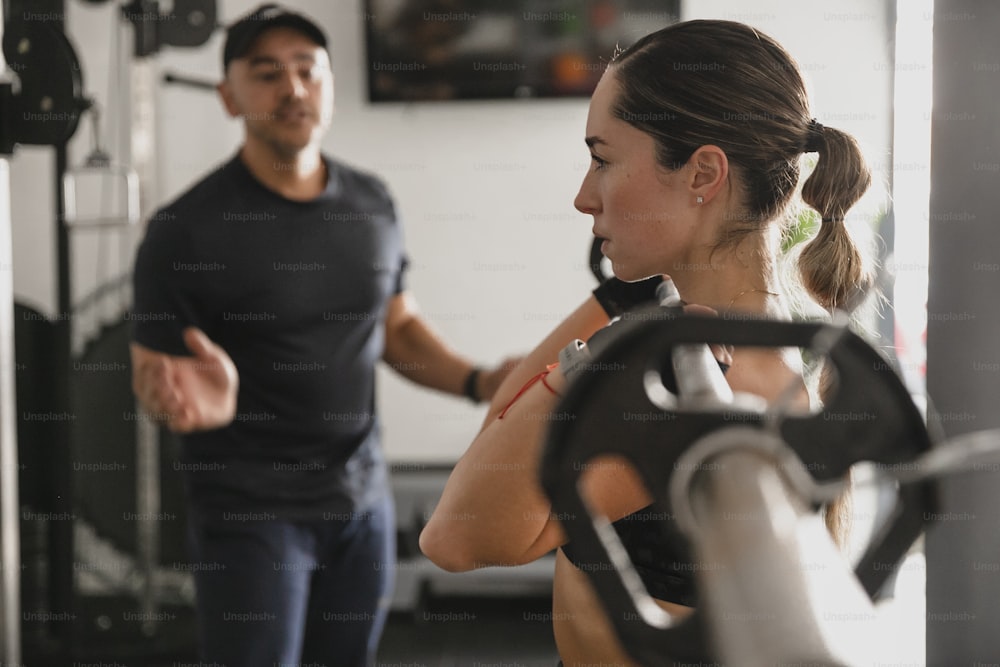 a man standing next to a woman in a gym