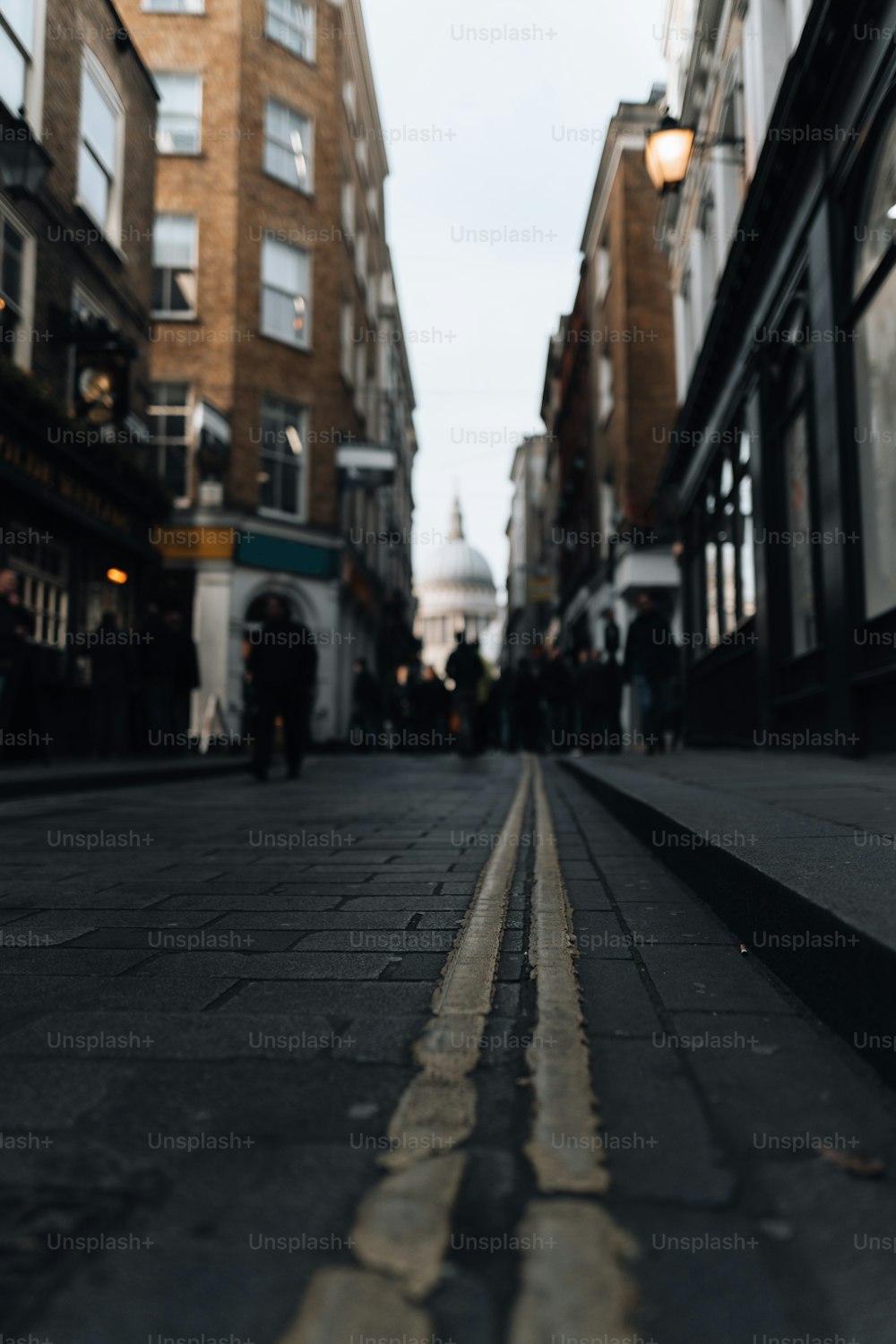 a city street with people walking down it