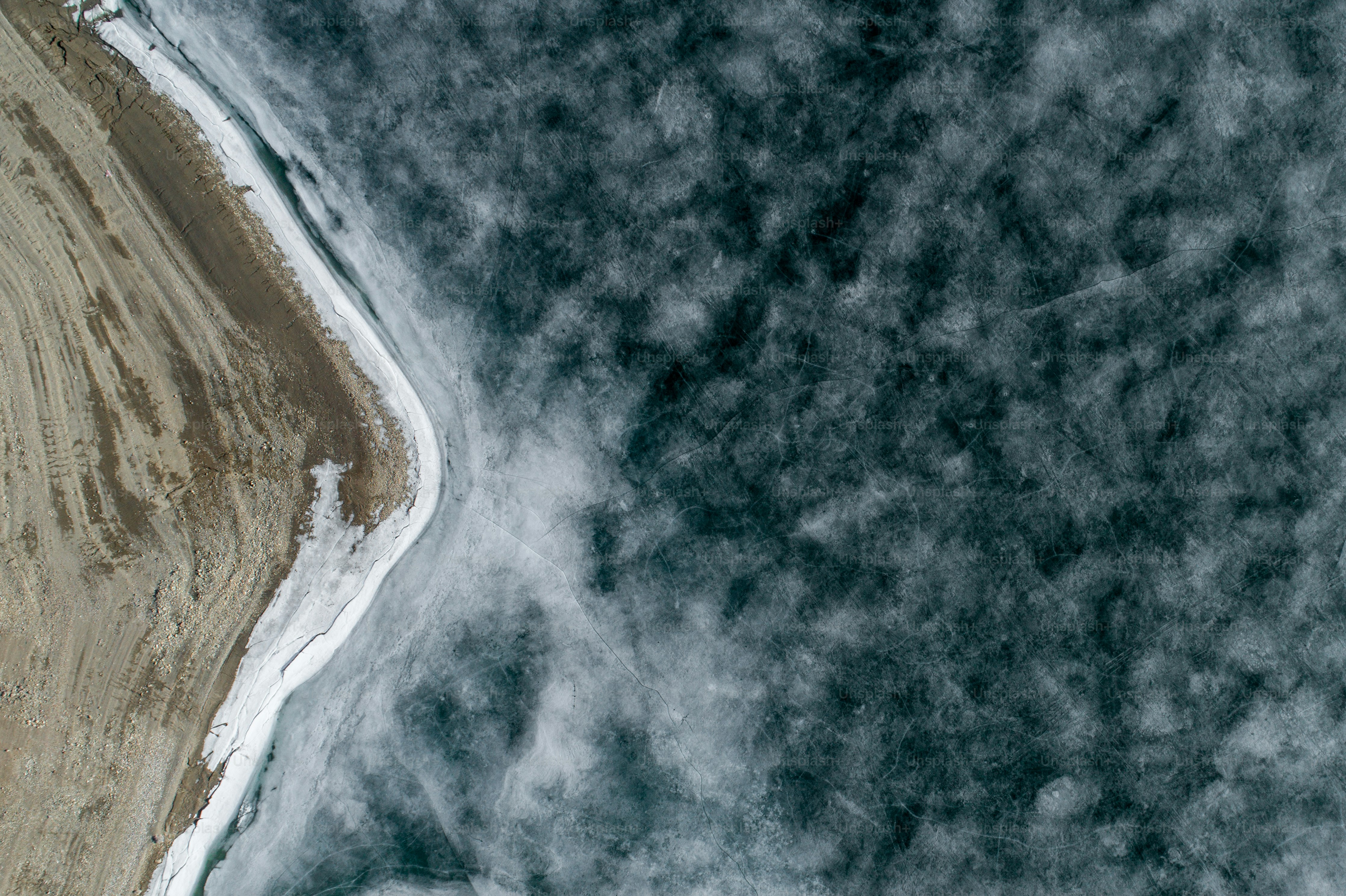 an aerial view of a sandy beach and ocean