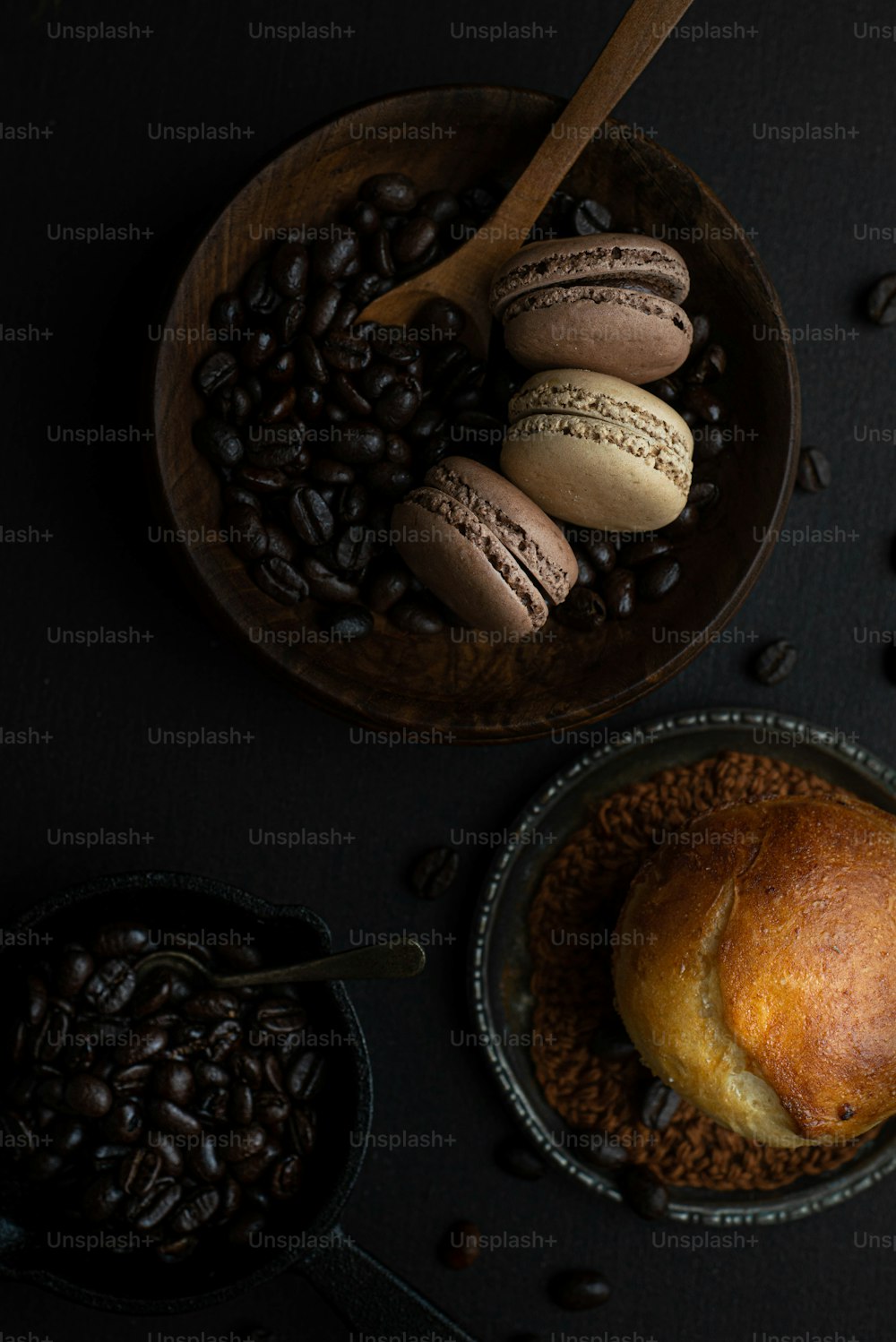 a table topped with a bowl of coffee beans and a loaf of bread