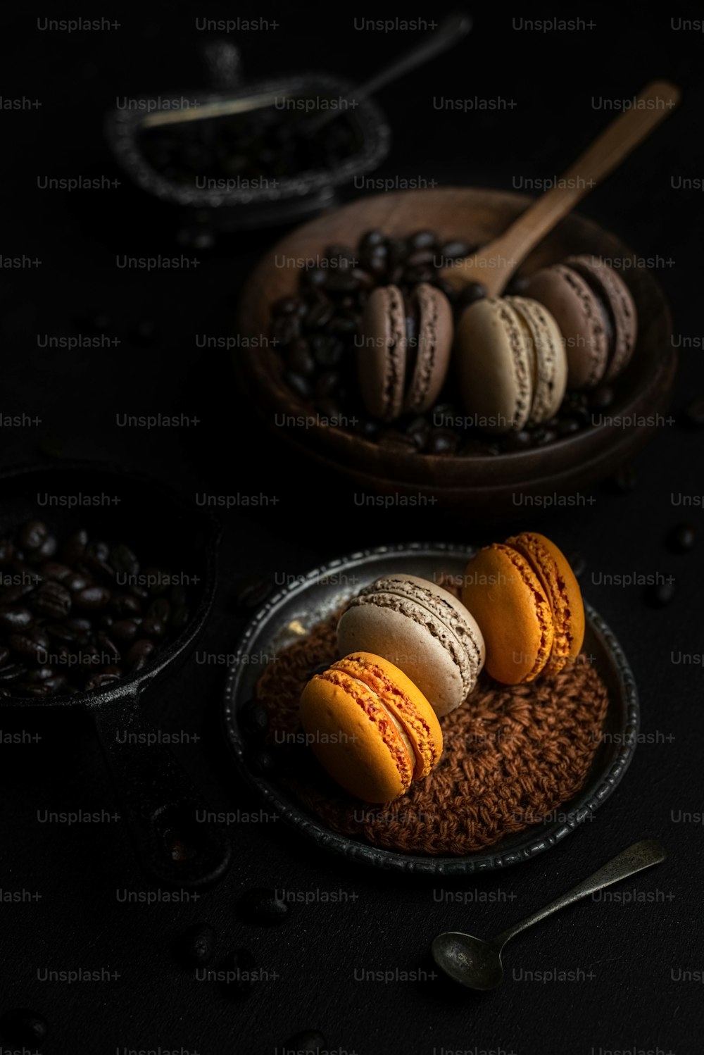 a plate of macaroons and coffee beans on a table