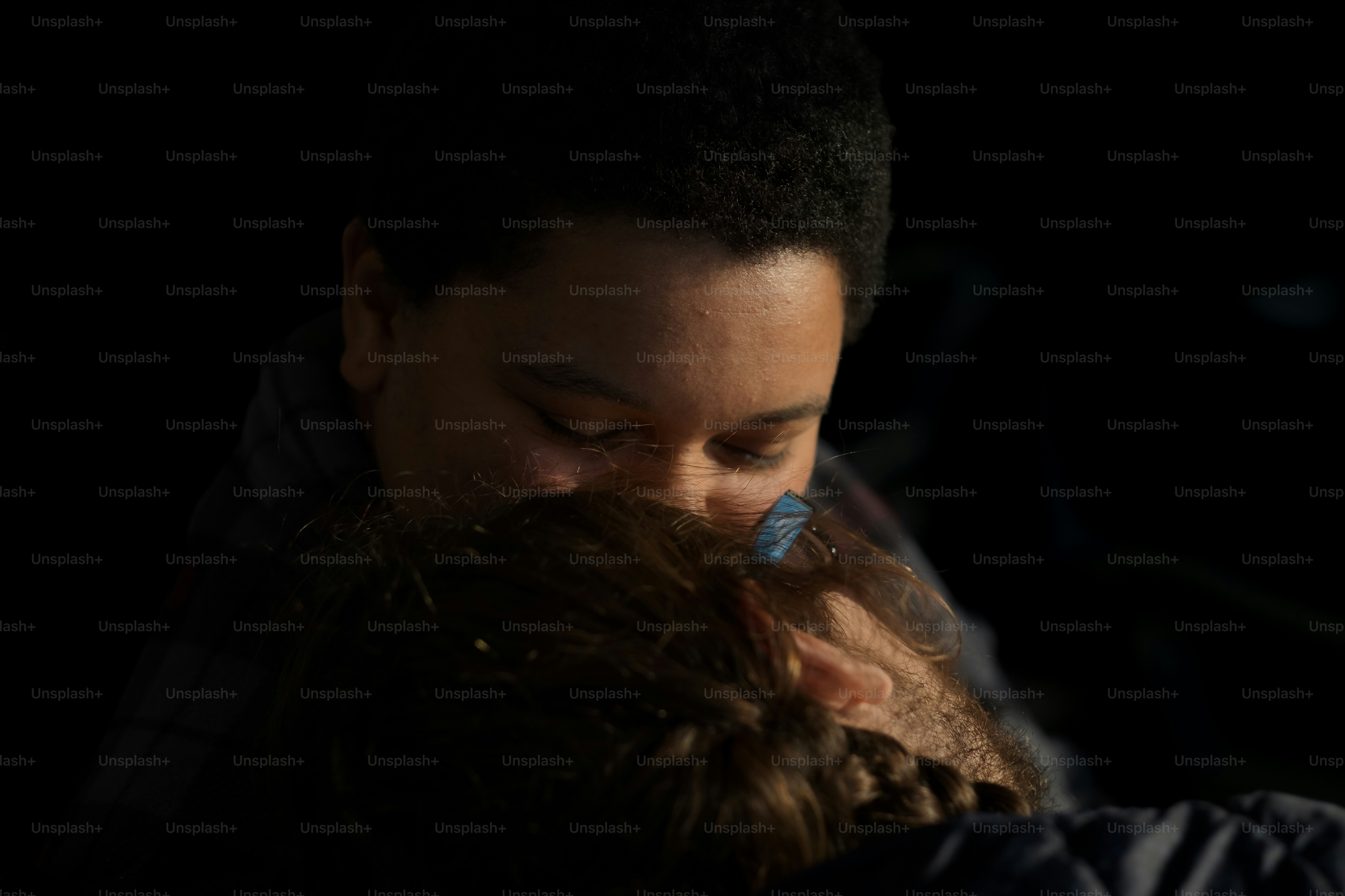 a man holding a child in his arms with a toothbrush in his mouth