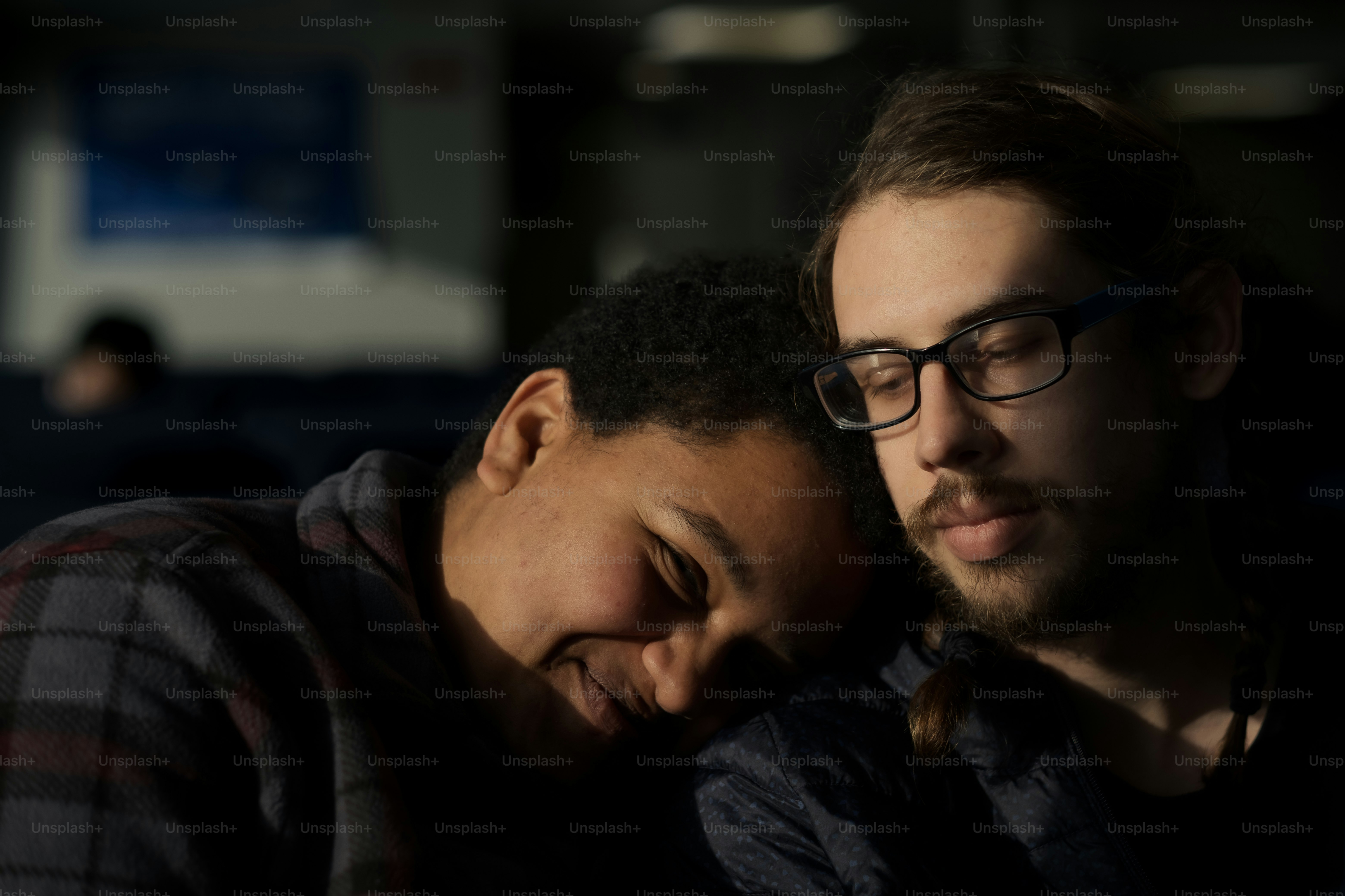 a couple of men sitting next to each other