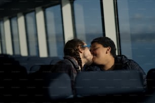 a man and a woman kissing on a bus